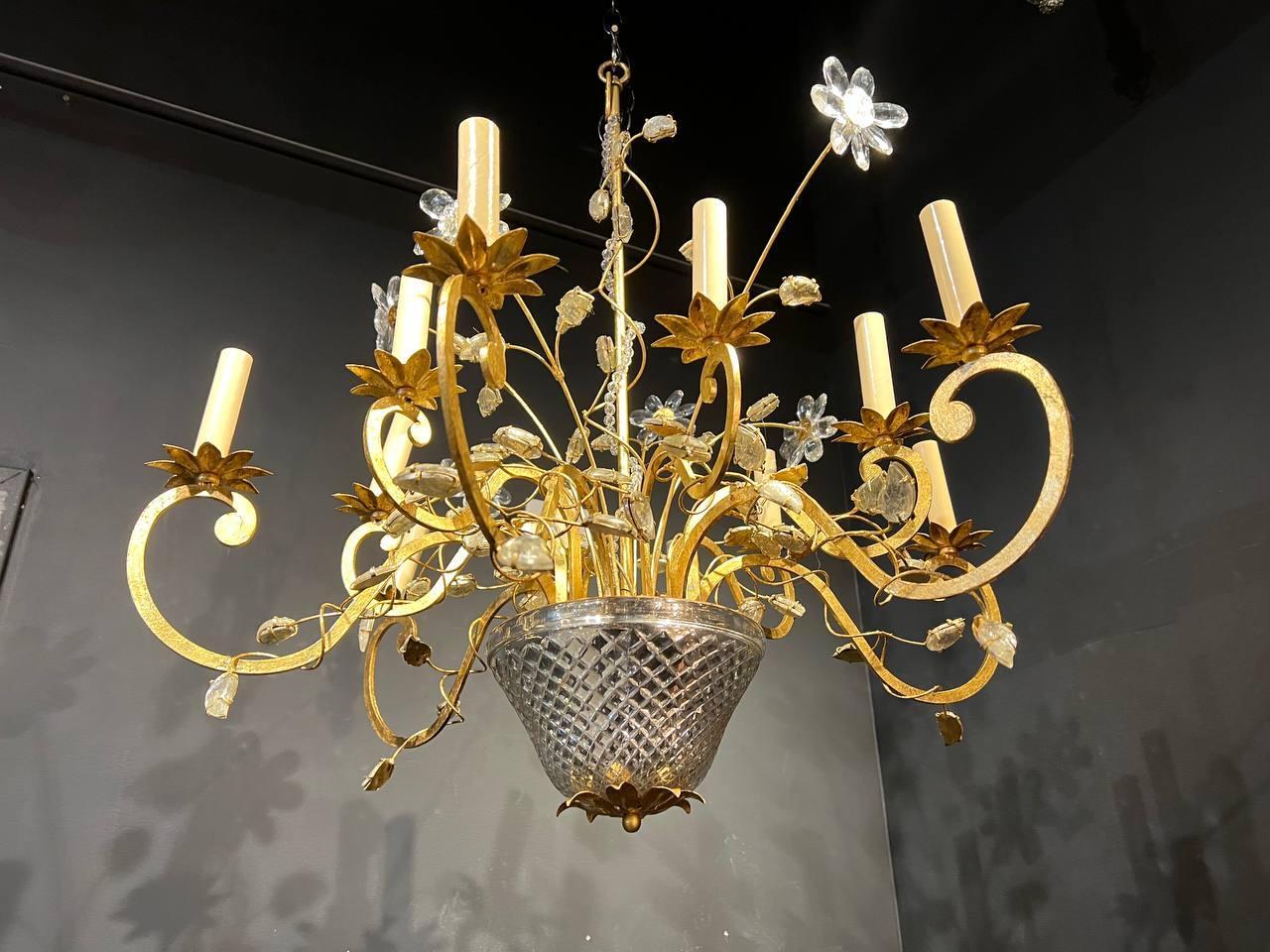 A circa 1930’s French gilt metal 12 lights chandelier with glass leave and body. In great condition.