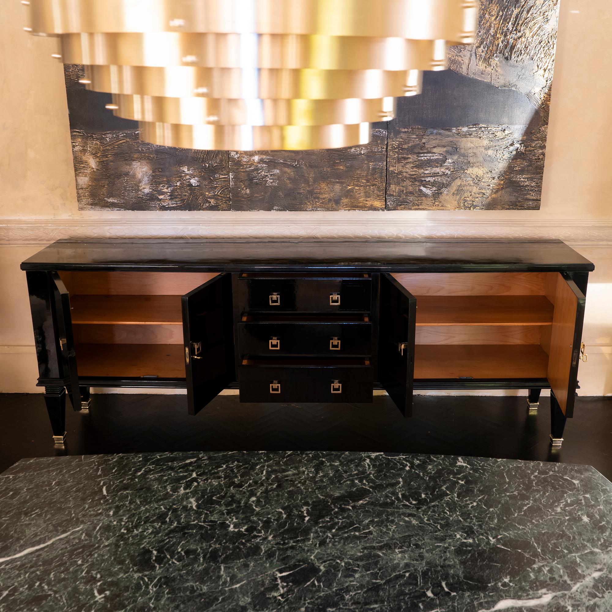 Mid-Century Modern black lacquered sideboard, oak structure with a shiny lacquered finish and brass hardware, perfect condition and vintage patina, France, 1940s.
     