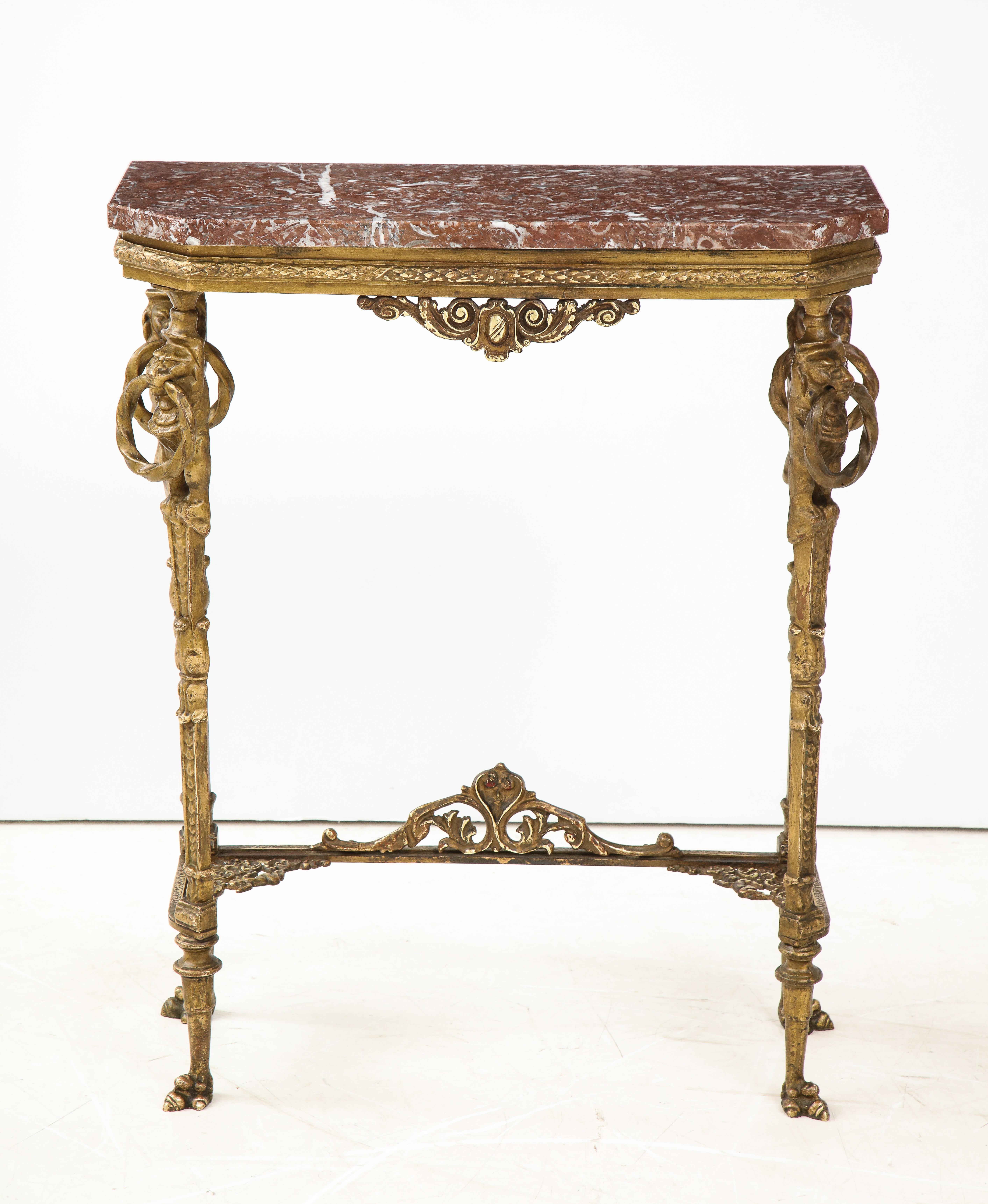 1940's bronze and marble French petite console with lion faces and feet motif, in vintage original condition with some wear and patina due to age and use.