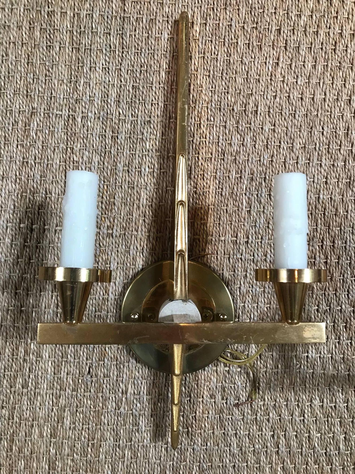 Newly wired golden sconces with plastic, wax candles.