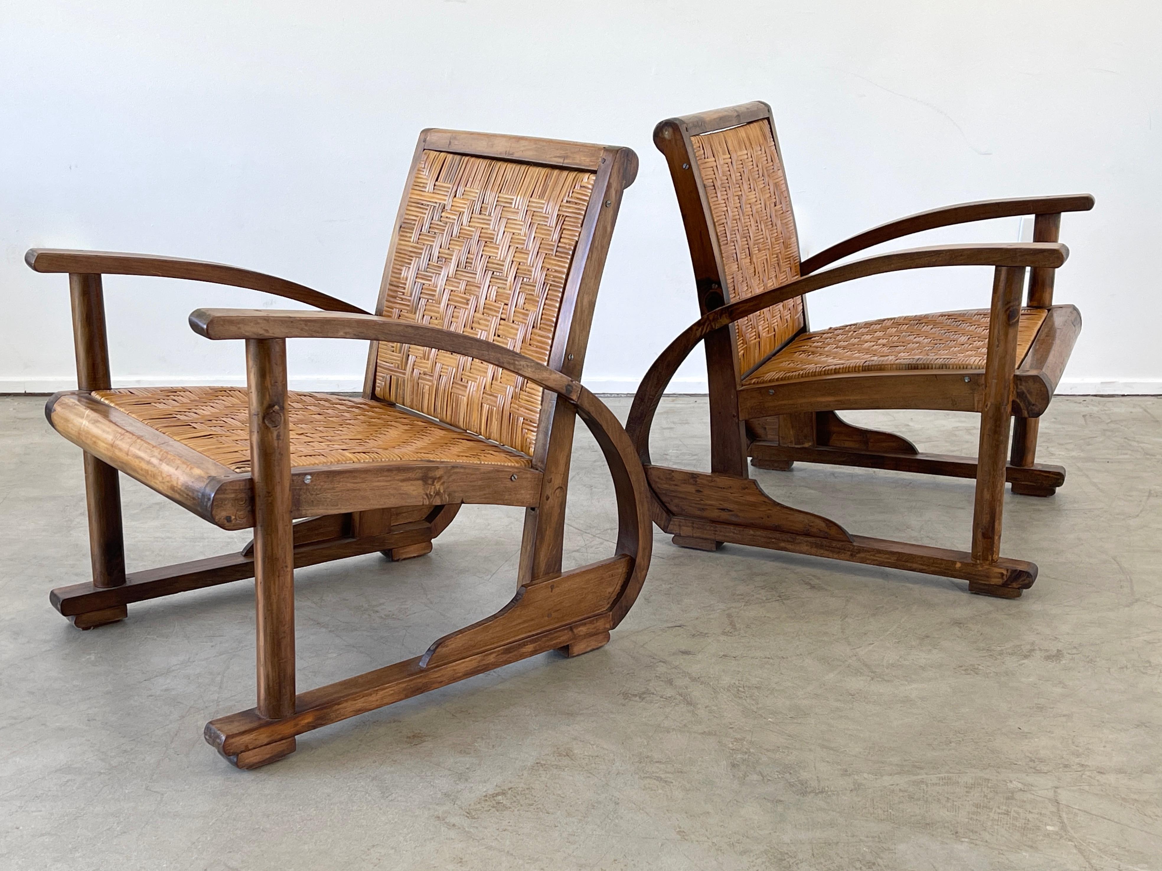 Pair of 1940's French Art Deco style chairs with curved oak frames and cane seat and backs. 
Great Sculptural shape and patina.