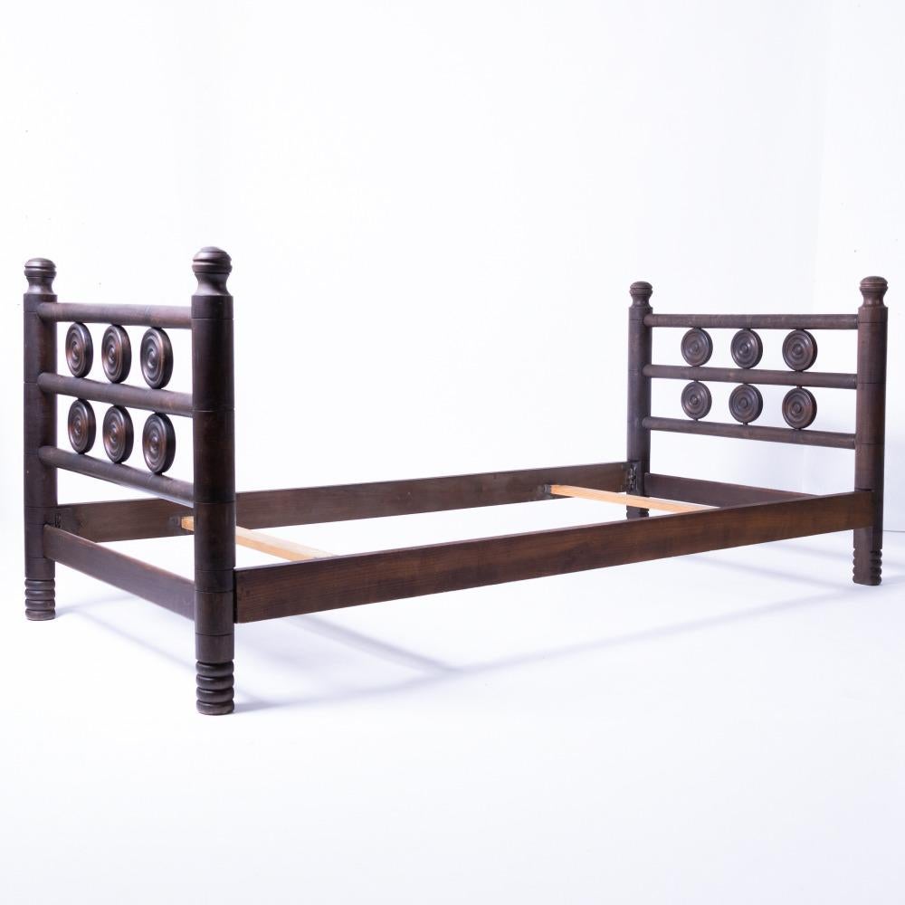 Incredible and rare vintage twin bed frame by Charles Dudouyt, circa 1940's France. 
Long oak wood frame with carved circle details. Original finish shows nice age and patina. Includes side rails and two slats. Beautiful statement piece. Perfect as