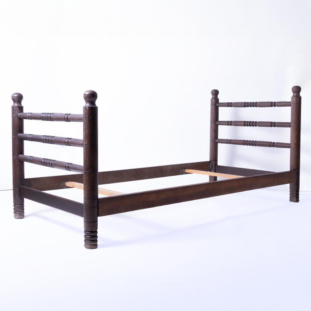 Incredible and rare vintage twin bed frame by Charles Dudouyt, circa 1940's France. 
Long oak wood frame with carved horizontal spindle detail. Original finish shows nice age and patina. Includes side rails and two slats. Beautiful statement piece.