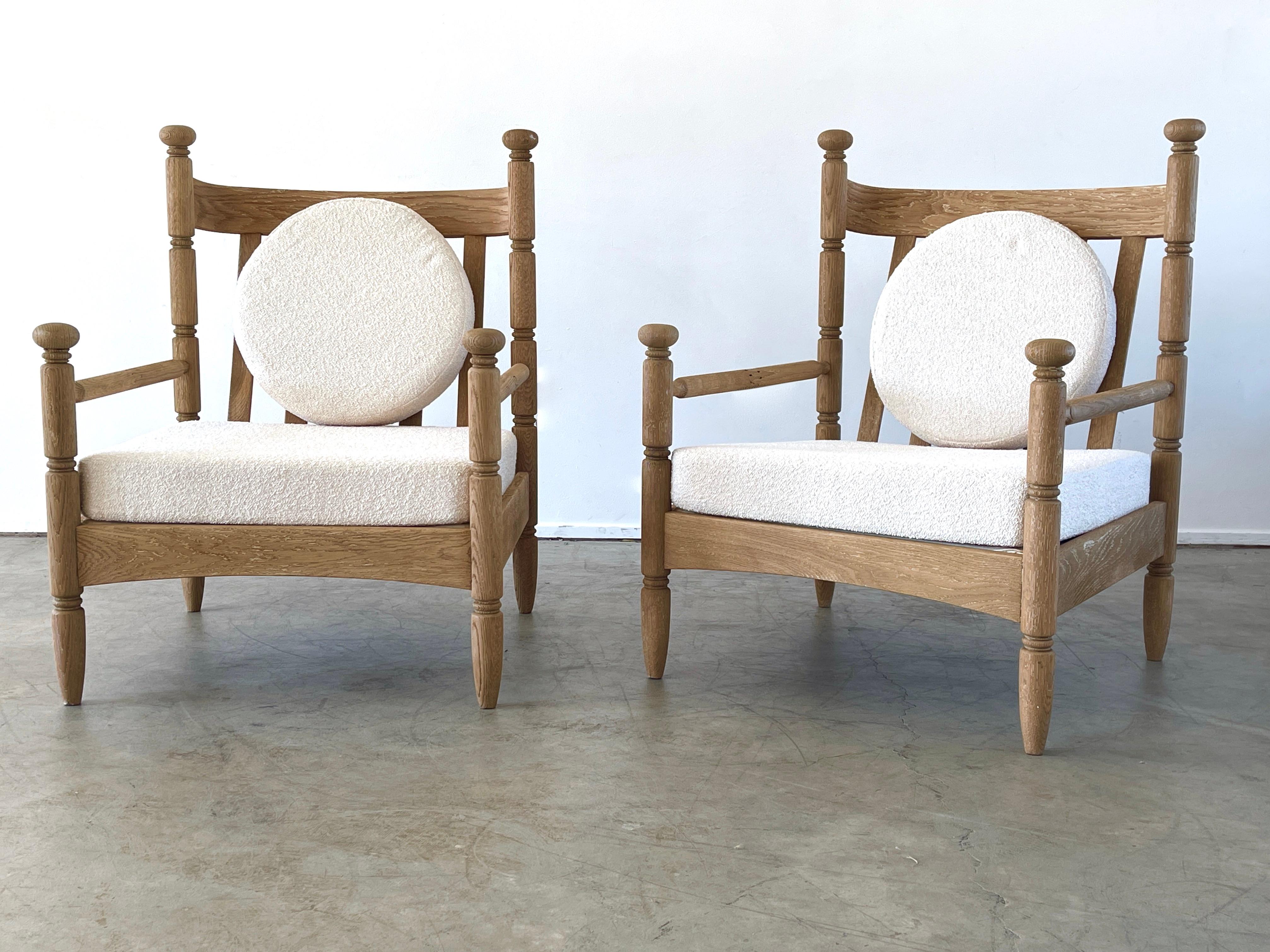 Pair of chairs in cerused oak with fantastic curved shaped back and carved legs. Newly upholstered in France in creamy boucle fabric with circular cushion