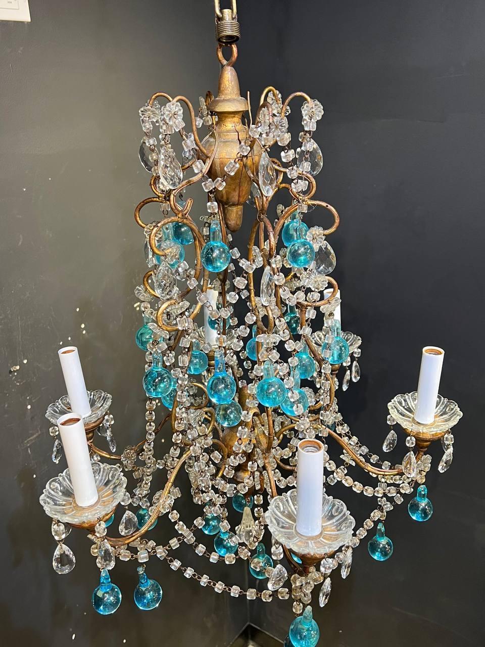 A circa 1940’s French gilt metal chandelier with macaroni crystals and unusual blue crystal hangings 