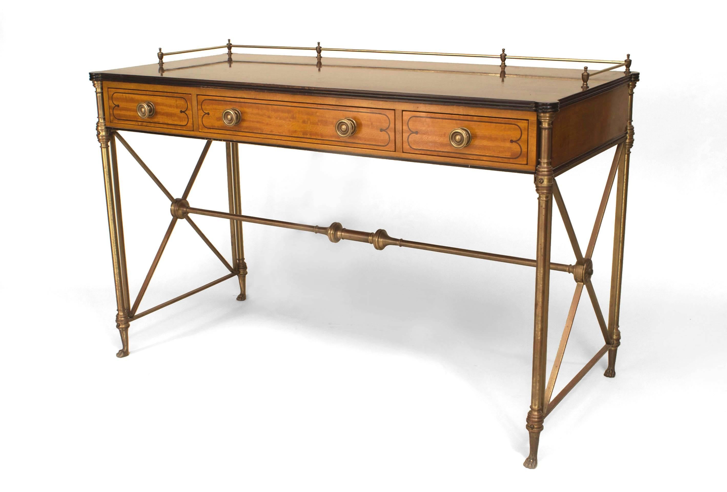 1940's French Charles X desk composed of maple with ebony inlay and a rectangular rosewood top with a brass gallery above three drawers and Neoclassical x-form legs. The desk is signed 