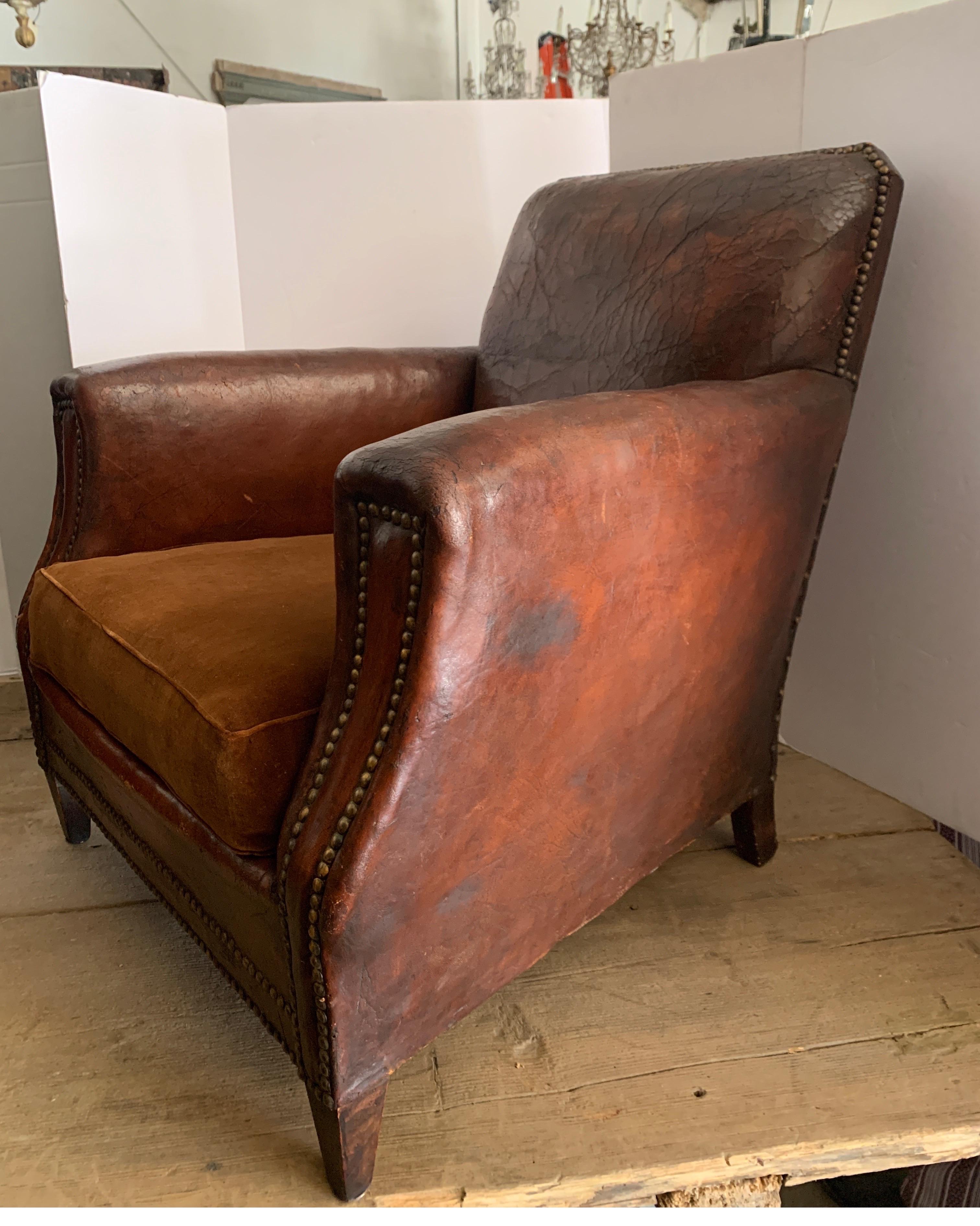 These are terrific leather chairs from France. They have amazing patina with that gorgeous color. There are a few places that have the leather separating and scratches that I have photographed. They are about 80 years old though.