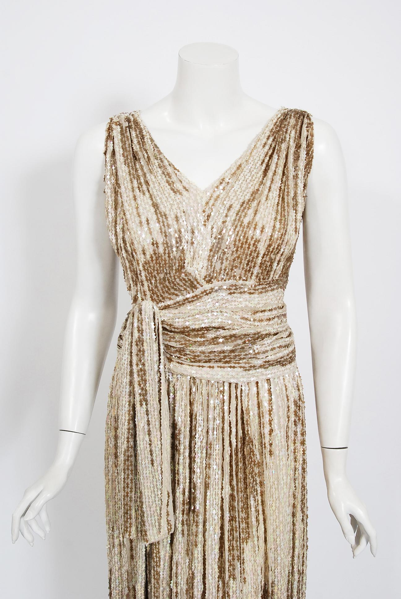 Sparkling gowns from the early 1940's era are perennial favorites and this French couture showstopper is breathtaking. The garment's simple fluid structure is so modern; the fine fantaisie paillettes sequins are a treasure trove of needle art. I