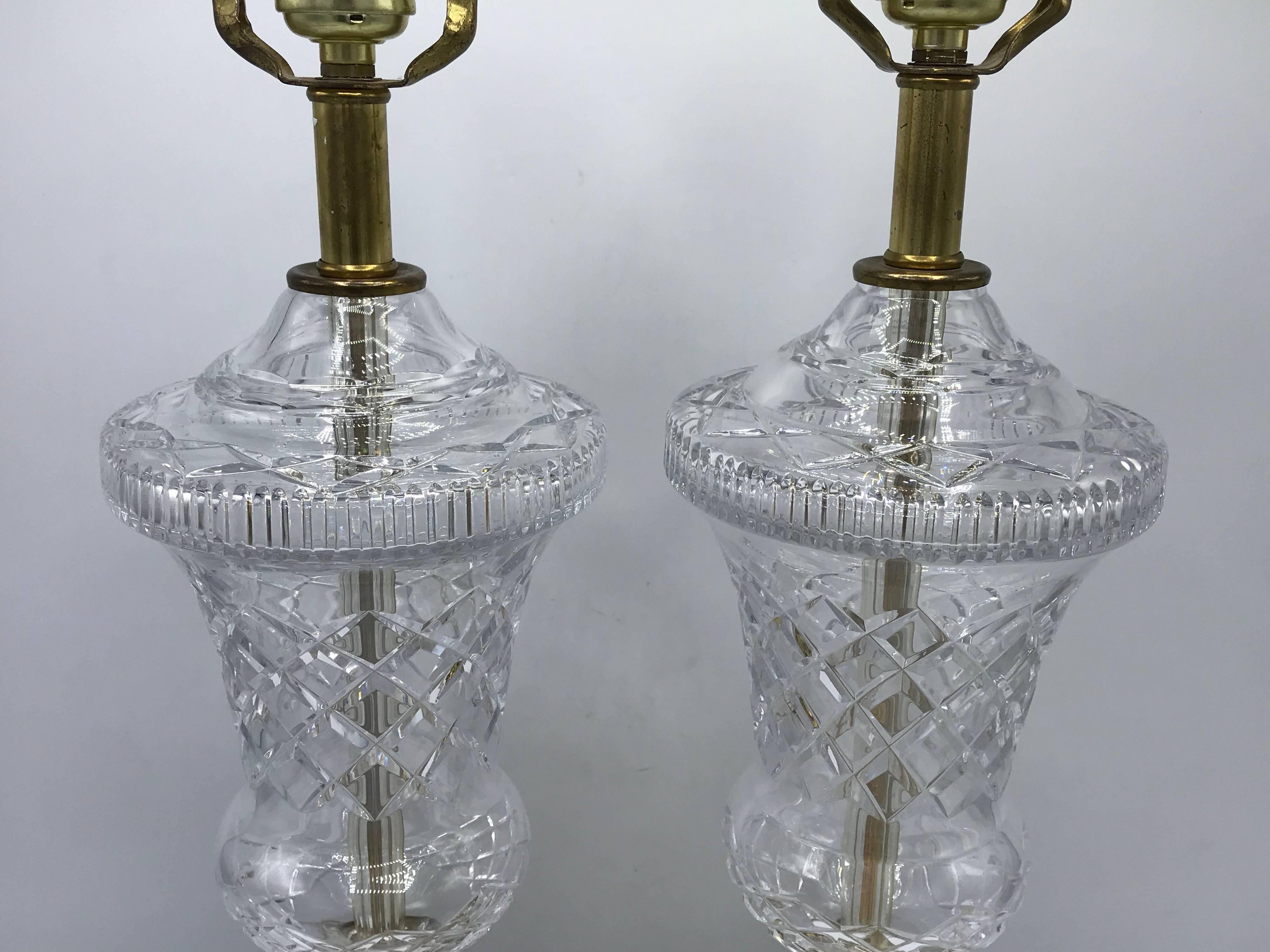Listed is a fabulous, pair of 1940s French neoclassical-style cut crystal and brass lamps. Stunning detail, and stands tall at nearly two feet, from base to socket. Extremely heavy.