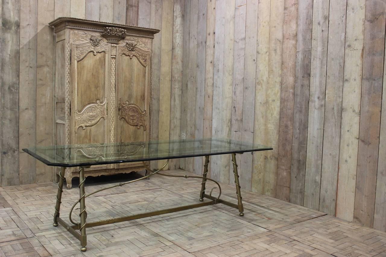 A superb quality and of great proportions, circa 1940s French interpretation of an 18th century dining table in brass with a thick bevelled glass top, that will easily seat eight people. 

As well as a dining table, this stylish and contemporary