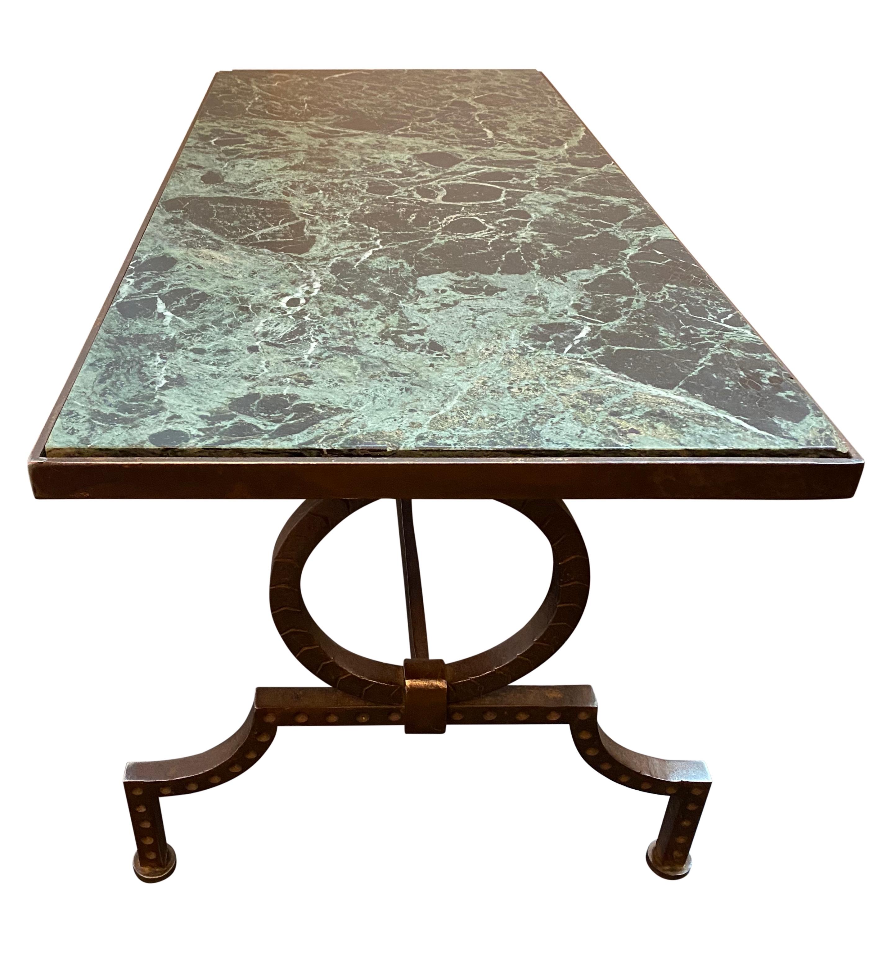Gilbert Poillerat coffee table with hand hammered wrought iron base and original green marble top.

Editorial - Gilbert Poillerat (Maître Ferronnier) Text: Francois Bandot (p.240), Preface Karl Legerfeld.


