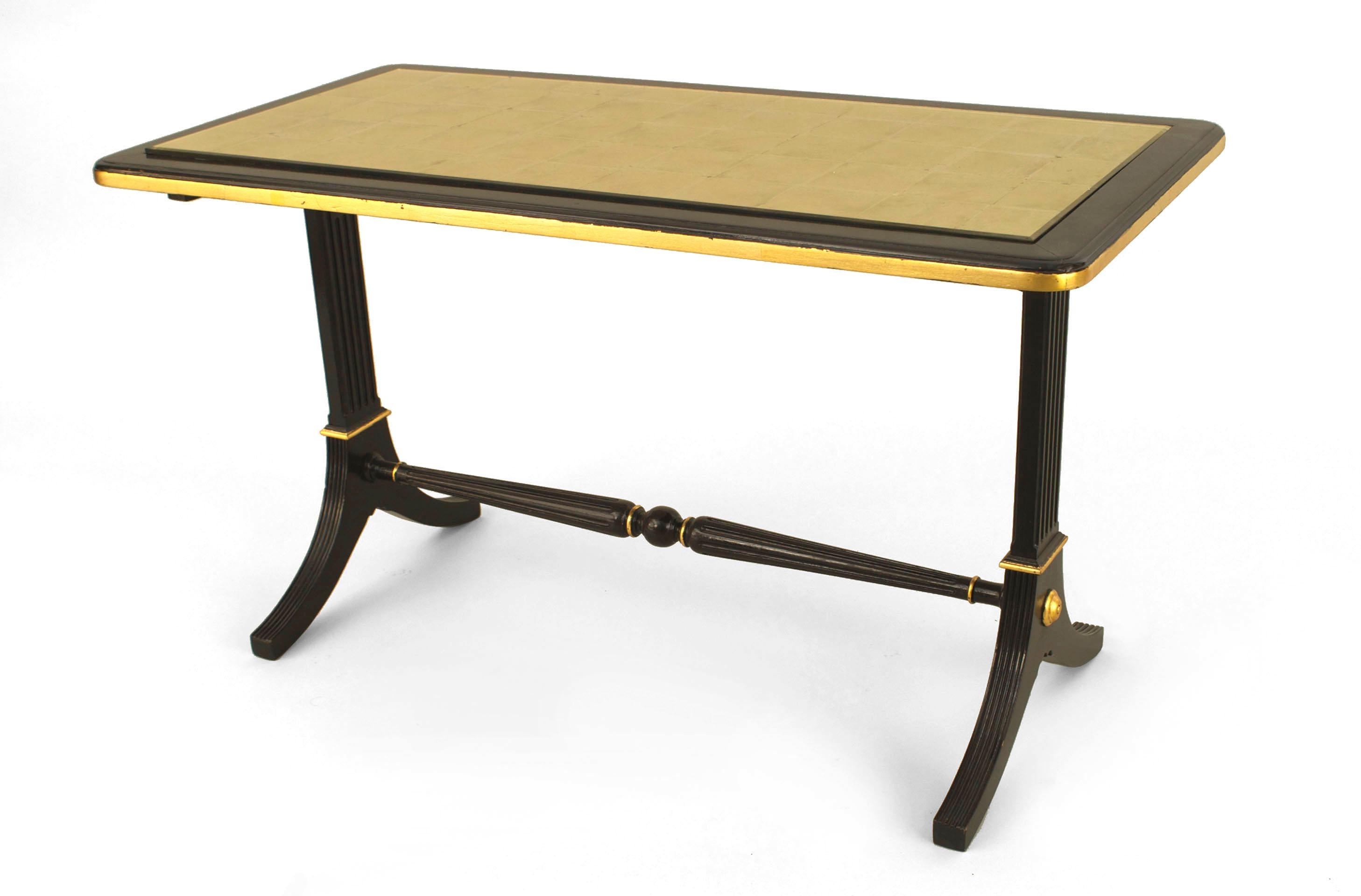 French Mid-Century (1940s) ebonized and gilt trimmed rectangular coffee table with pedestal sides connected with a stretcher and an inset gilt glass top. (stamped: JANSEN)
