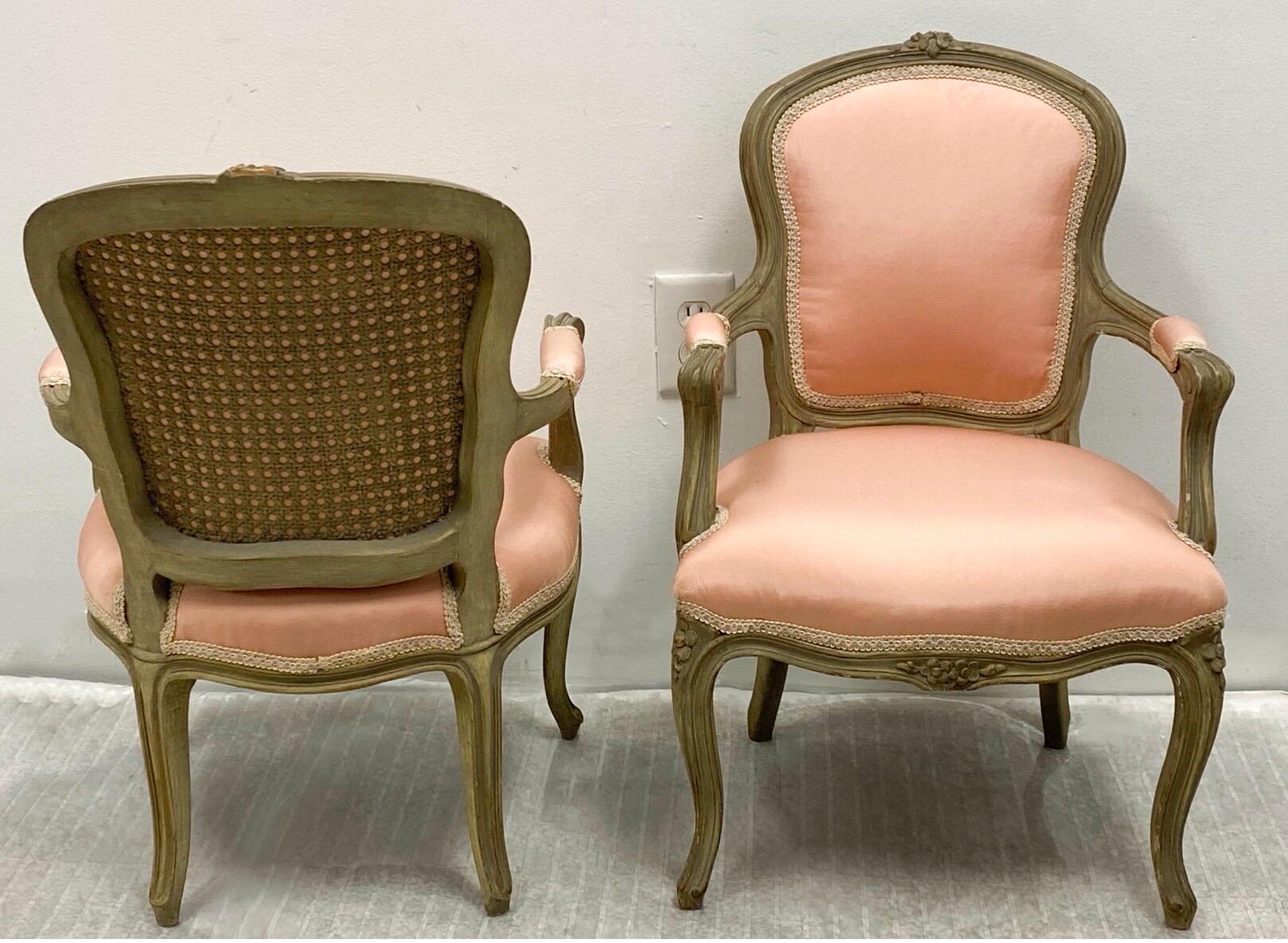 This is a whimsical pair of French children’s bergere chairs. The frame is a French gray, and the vintage upholstery appears to be a pink silk or taffeta. They are in very good condition. They most likely date to the 40’s.