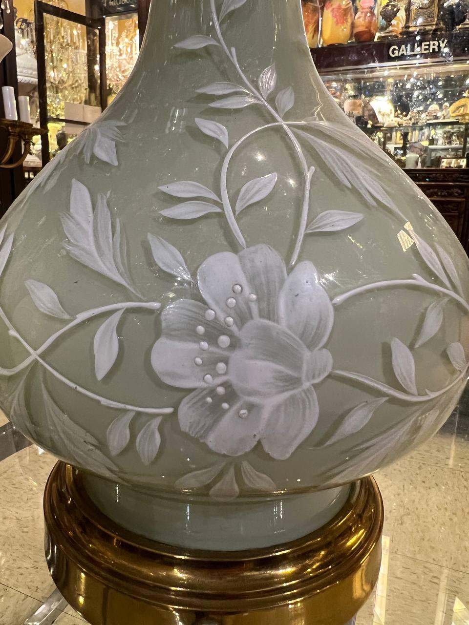 A pair of circa 1940's French light green glass table lamps with hand painted flowers design