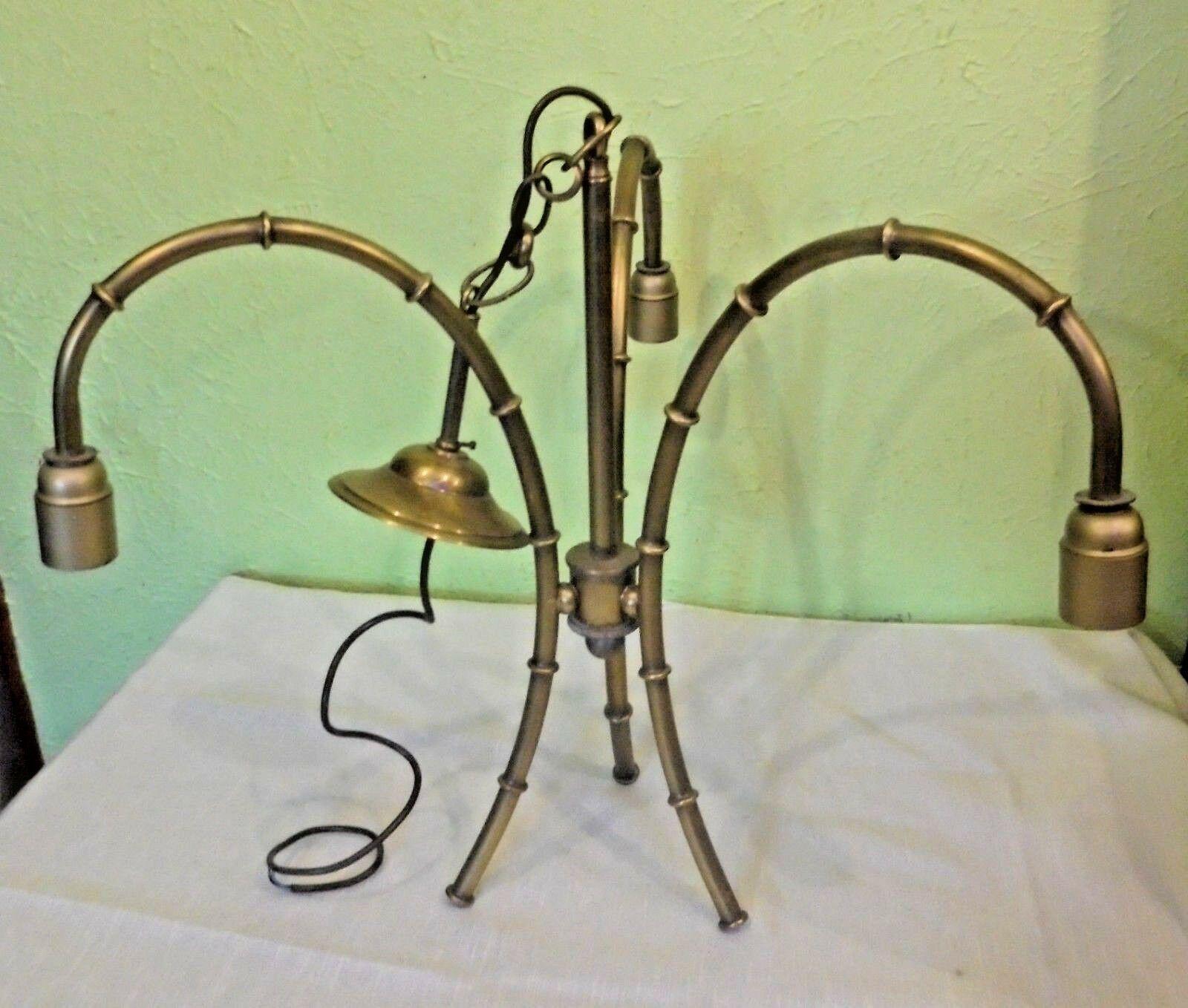 French 1940's Hollywood Regency Brass Faux Bamboo Chandelier. A minimalist chandelier here in the style of Bagues.