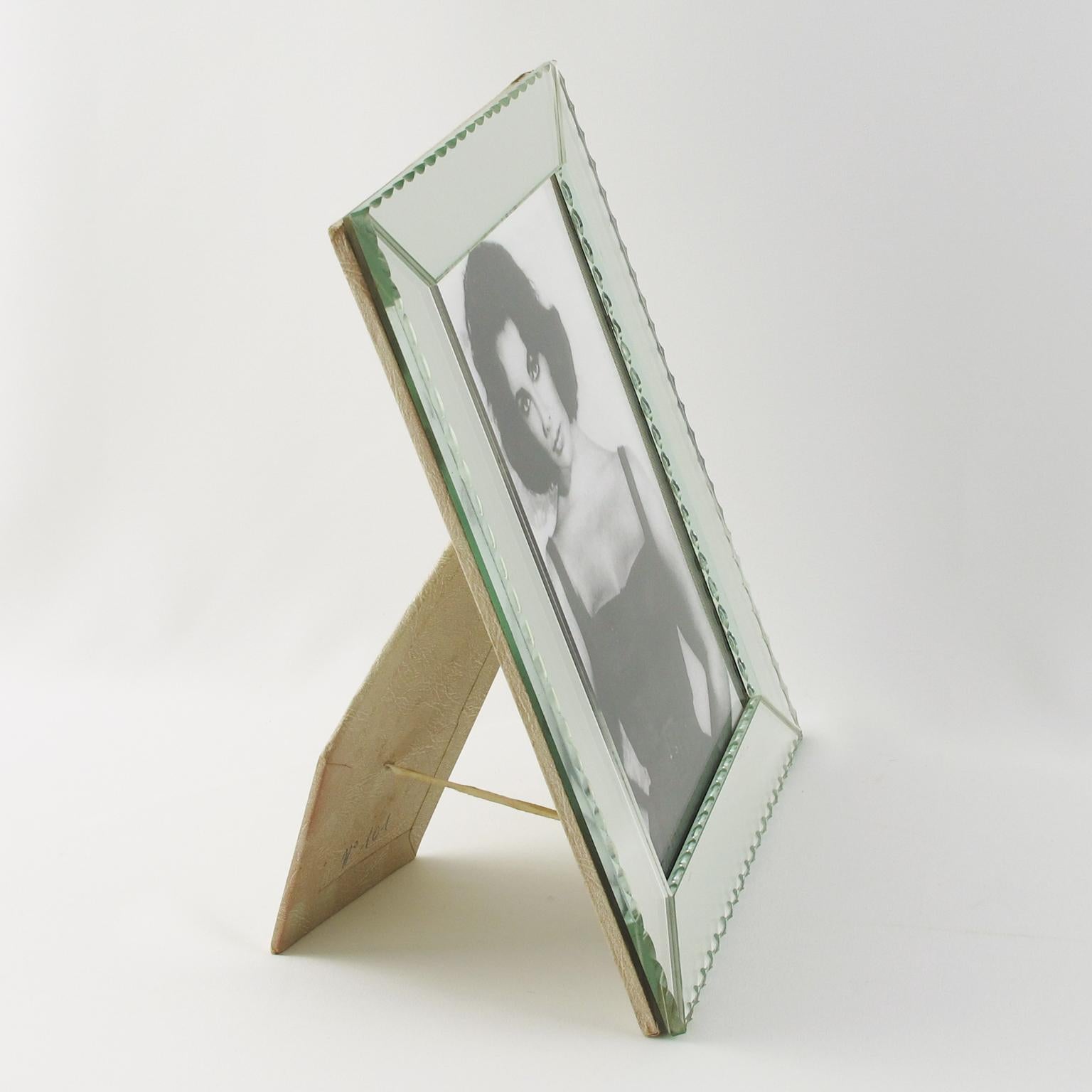 Elegant French Hollywood Regency mirror picture photo frame. Lovely clear mirrored glass beveled edges with geometric design. The picture frame can be placed either in portrait or in landscape position. Easel and back in decorative