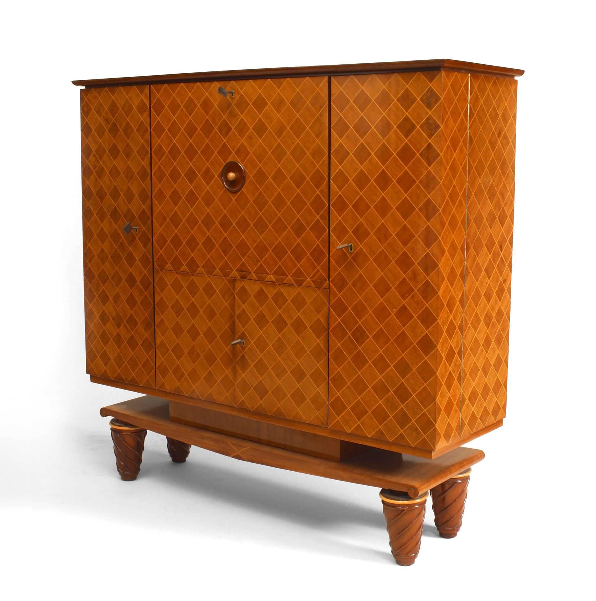 French Mid-Century (1940s) walnut & satinwood inlaid diamond design bar cabinet on platform base with swirled legs and bronze detail. (fully fitted interior/glass top)
