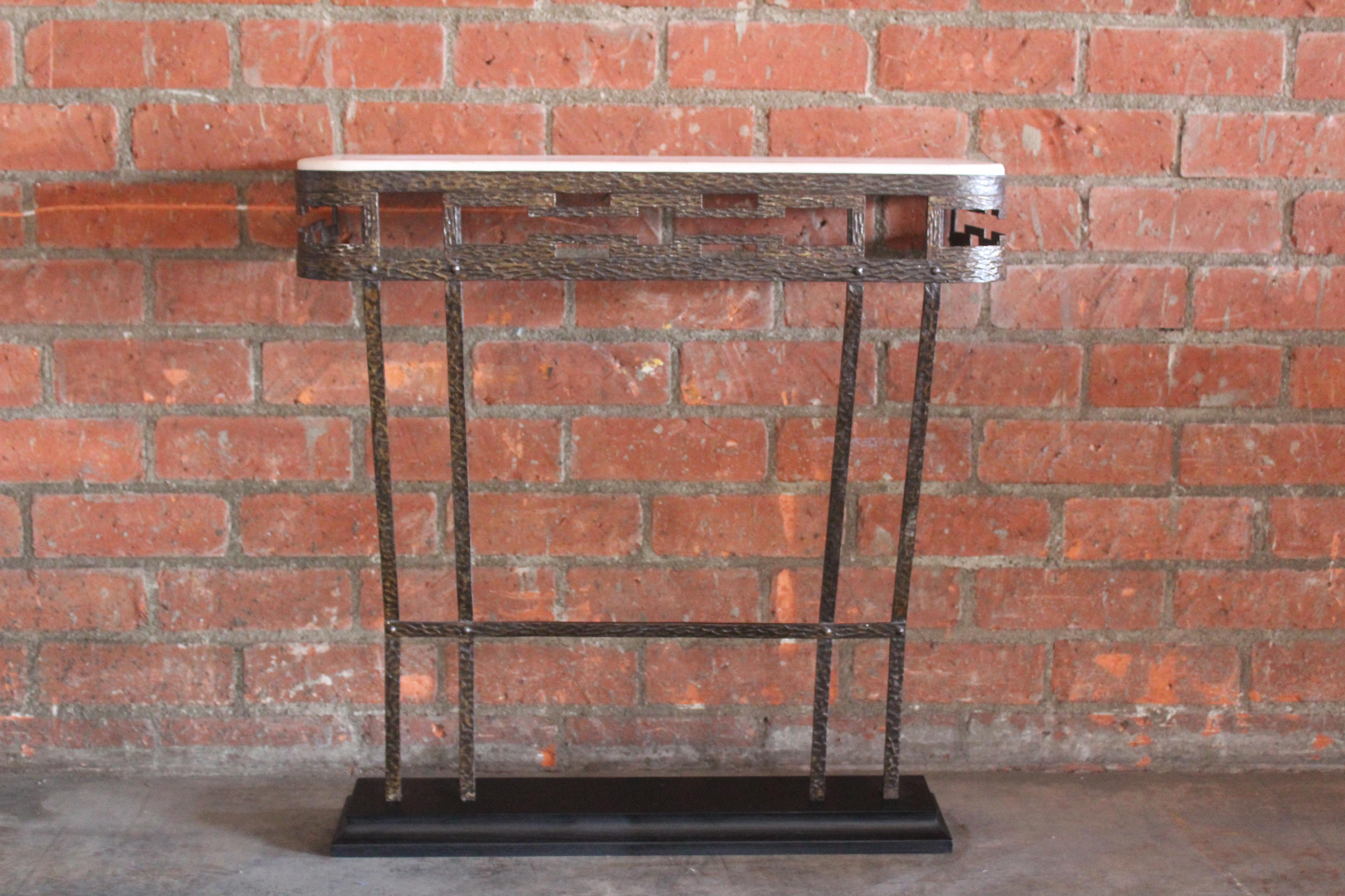 A vintage 1940s French iron wall console with a new limestone top and ebonized oak base. Mounts on the wall with two screws from behind.