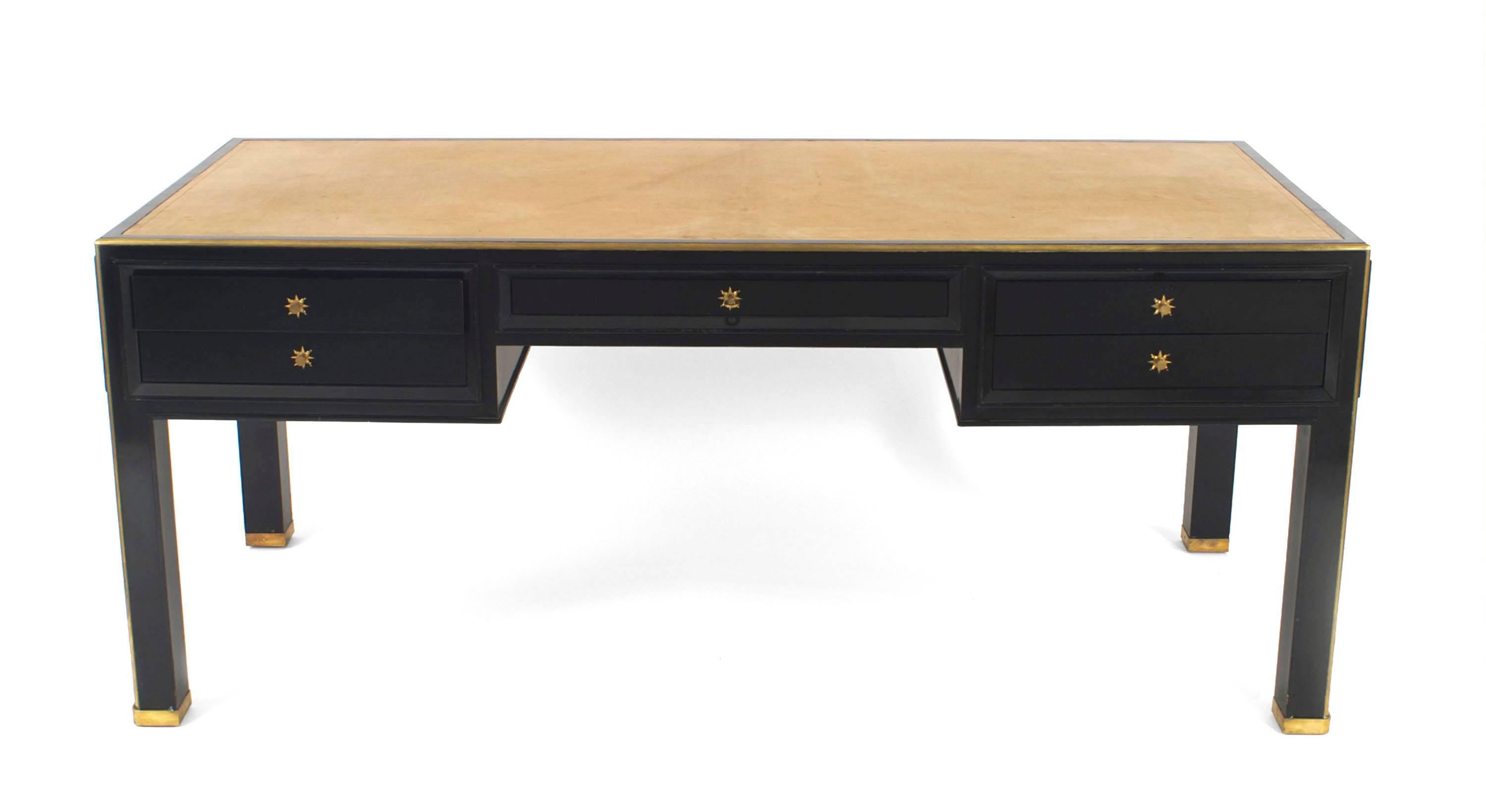French 1940s brass mounted black lacquered bureau plat /writing desk with tan leather inset top above a range of frieze drawers (attributed to Jacques Adnet).
 