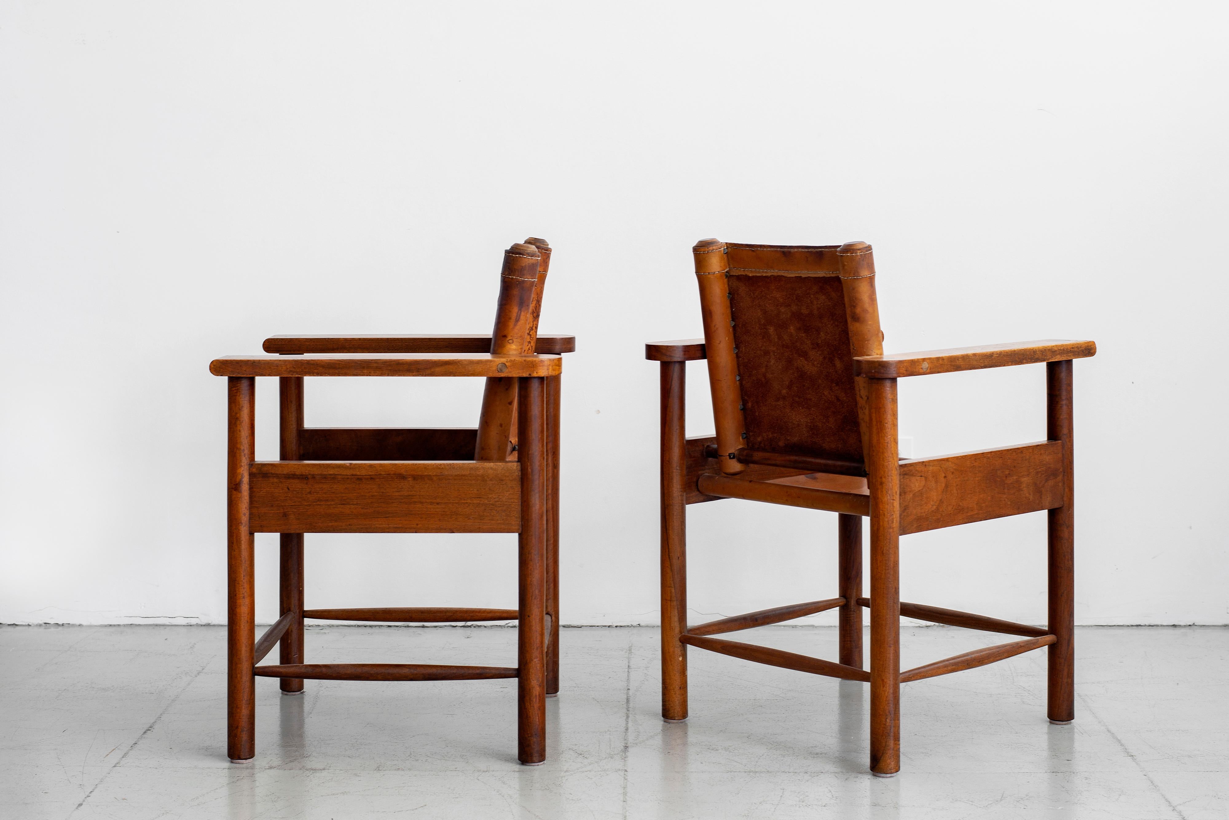 Fantastic pair of 1940s French leather chairs with plank oak armrests. Ornate detailing / construction with wonderful patina to leather and oak.