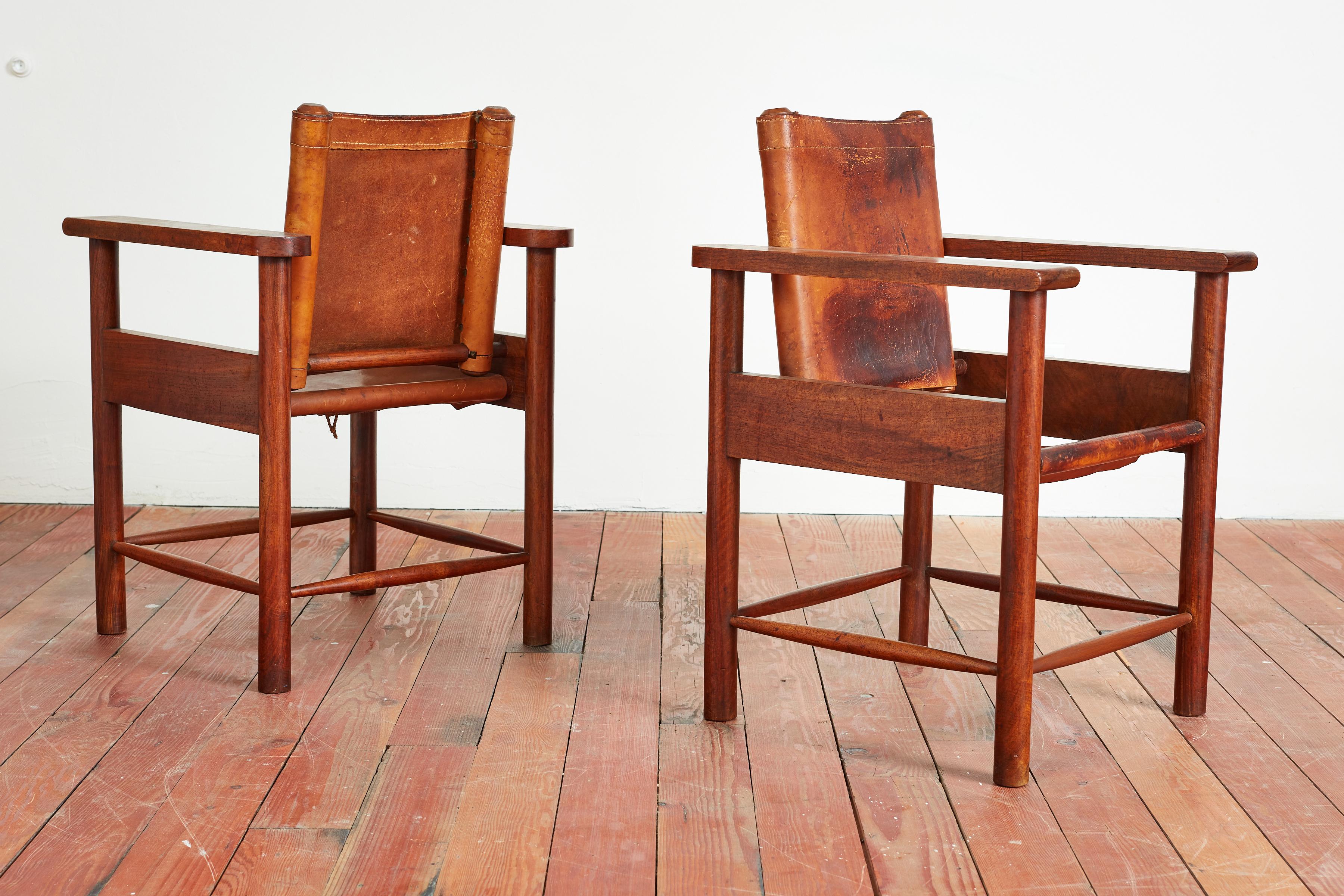 Fantastic pair of 1940s French leather chairs with plank oak armrests. Ornate detailing / construction with wonderful patina to leather and oak.