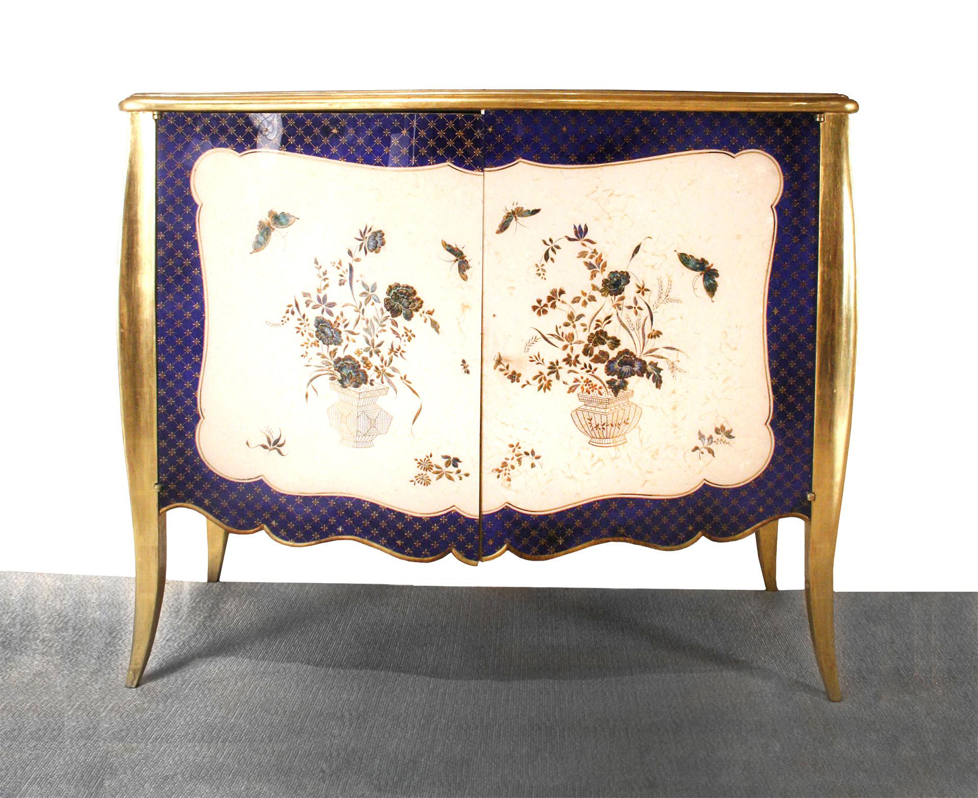 French Louis XV style (1940s) blue and gilt trimmed serpentine shaped commode with 2 lucite over √©glomis√© front doors having a floral and butterfly design.
