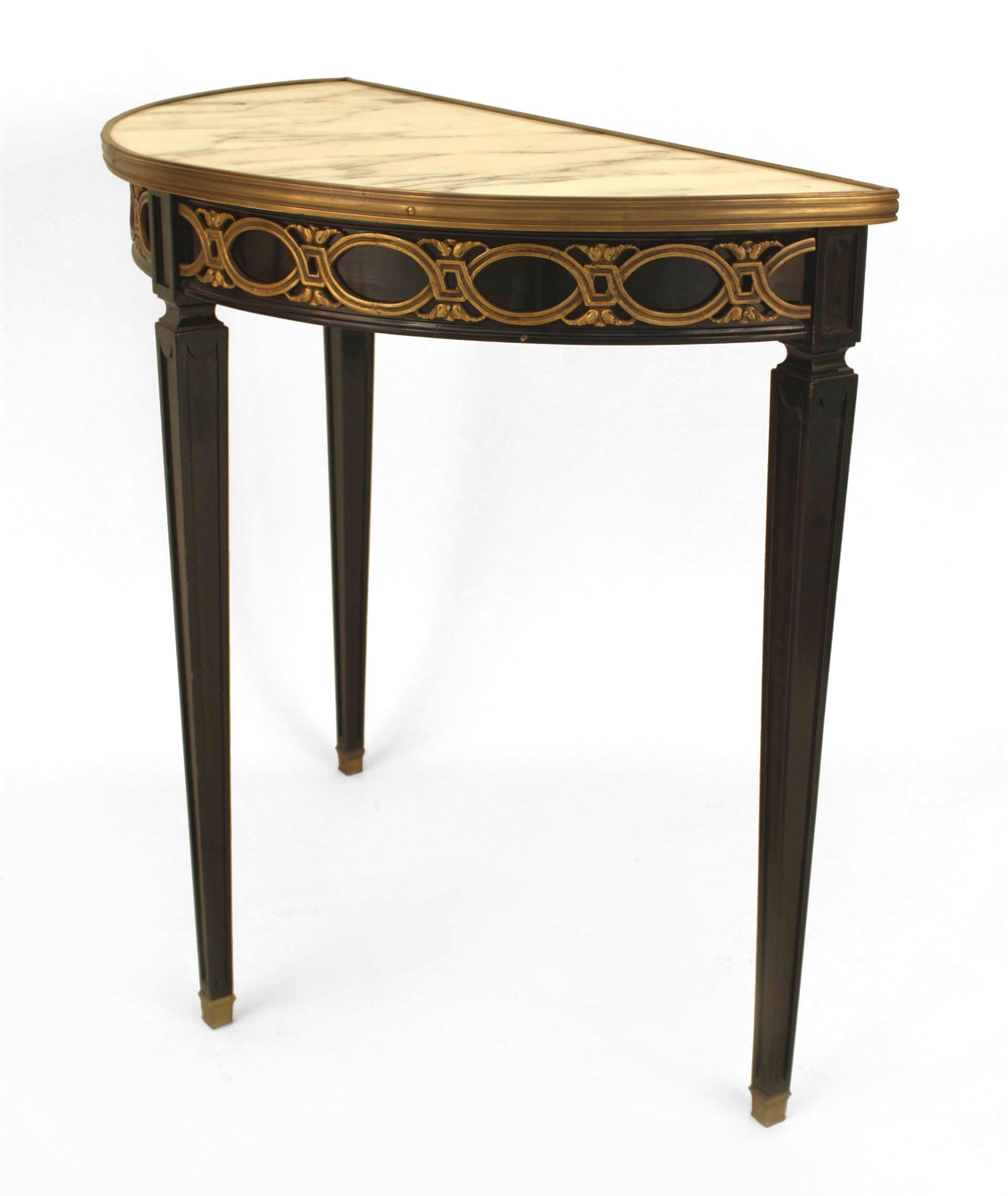 French Louis XVI-style (1940s) ebonized demilune shaped console table with a bronze scroll design apron under an inset white marble top with tapered square legs. (stamped: JANSEN)
