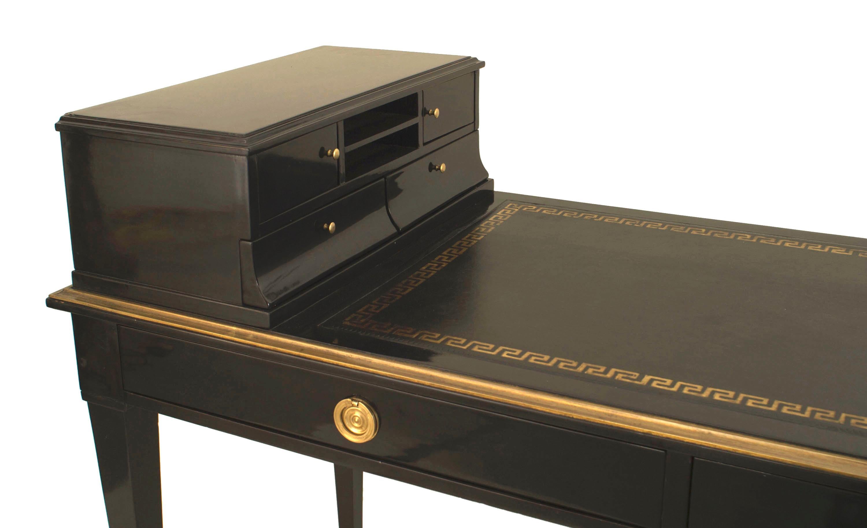 French Louis XVI style (1940s) ebonized & gilt bronze trim desk / cartonnier with 2 drawers and a black leather & gold tooled top supported on 4 tapered square legs. (stamped: JANSEN)
