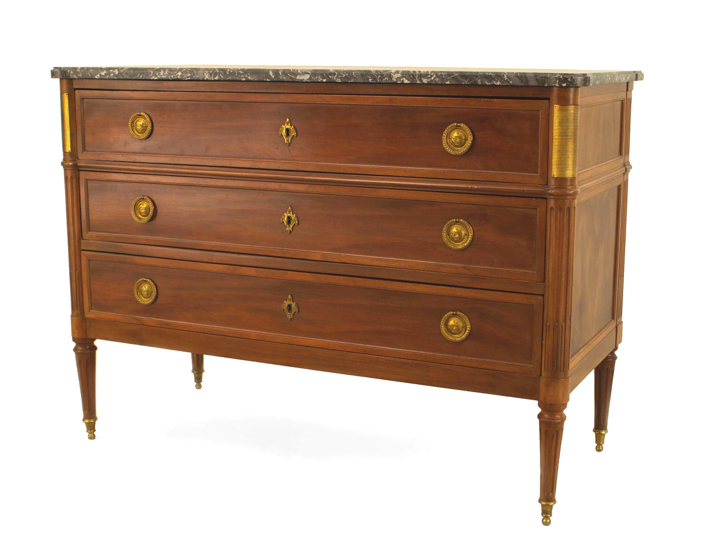 French Louis XVI style (1940s) mahogany and gilt bronze trimmed chest with 3 drawers having ring handles and a marble top. (stamped: JANSEN)
