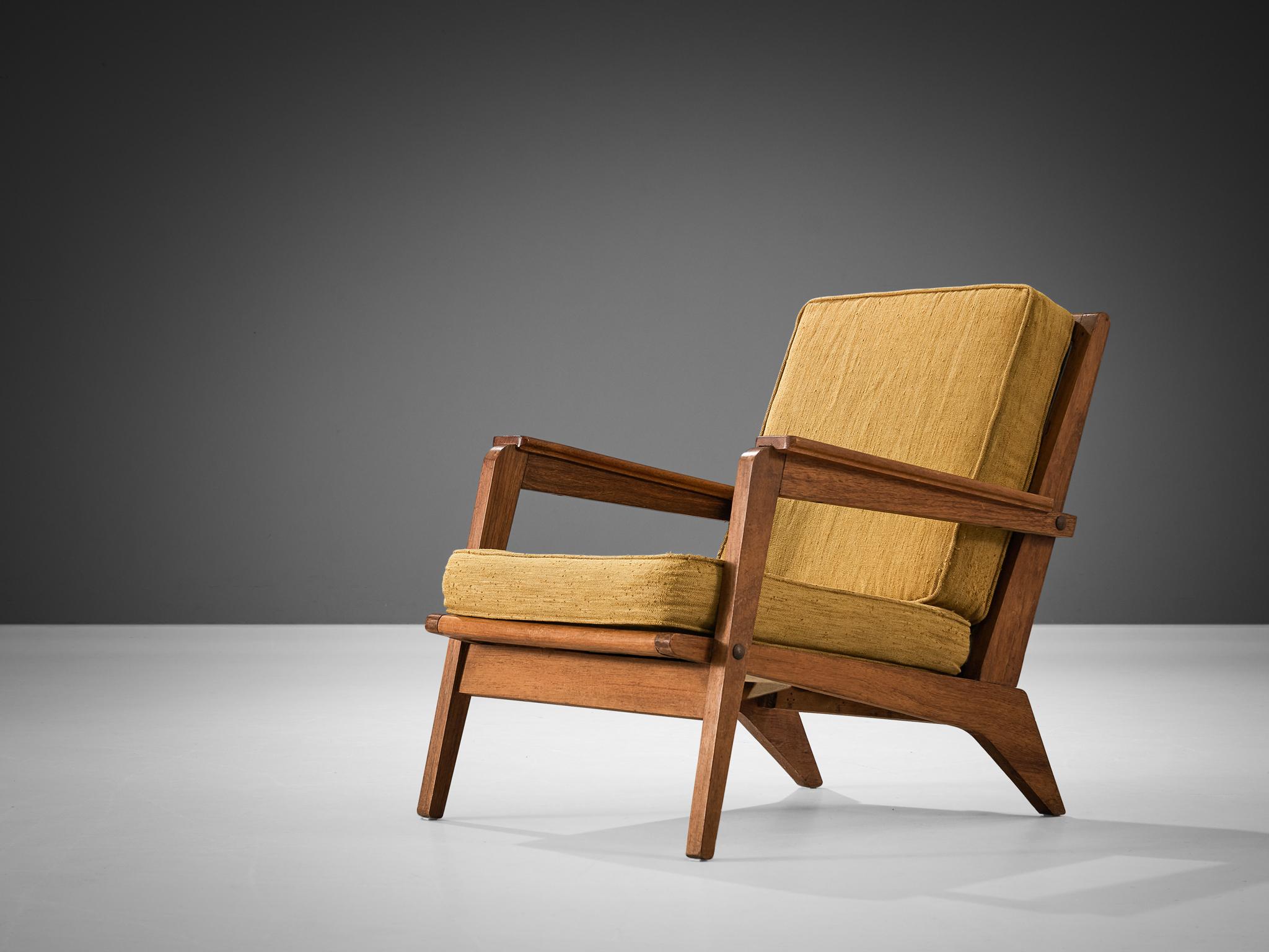 Lounge chairs, ocher yellow fabric, wood, France, 1940s. 

This armchair strongly remind of the iconic chairs created by the talented French designer René Gabriel (1899-1950), who is known for his constructivist approach to furniture design. The