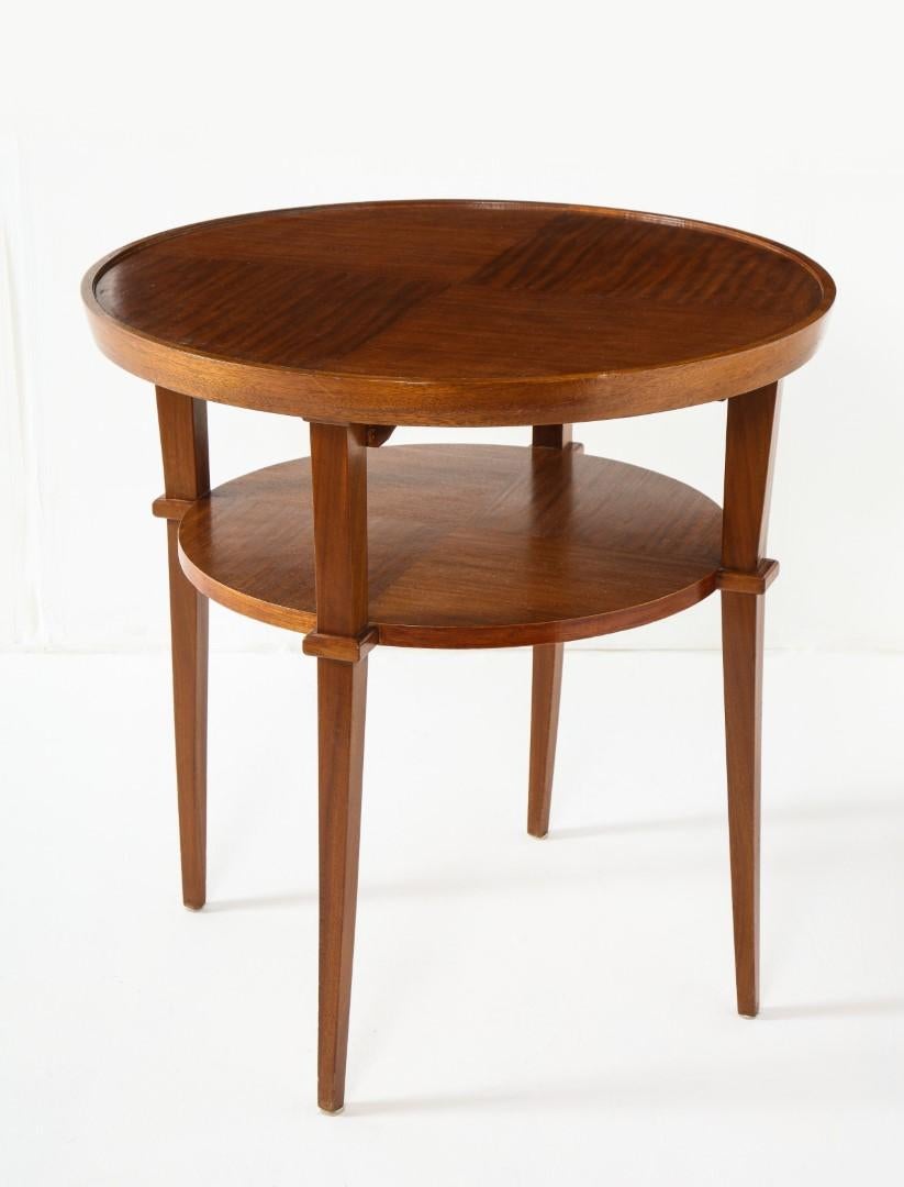 Round side table with two tiers and tapered legs, mahogany, French 1940s.