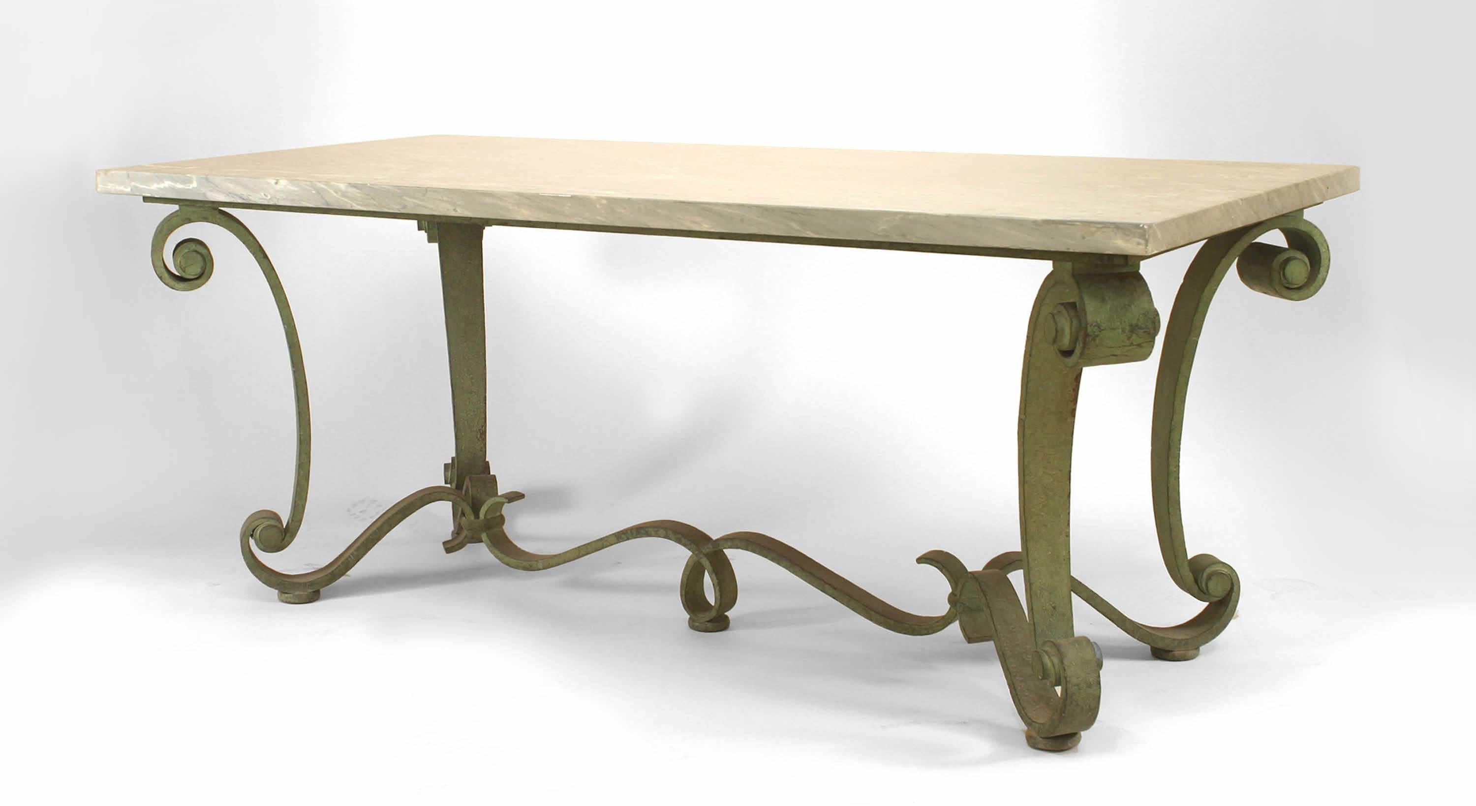French 1940s green patinated iron center table with rectangular grey marble top on volute scrolled legs joined by a stretcher. (attributed to RAYMOND SUBES)
