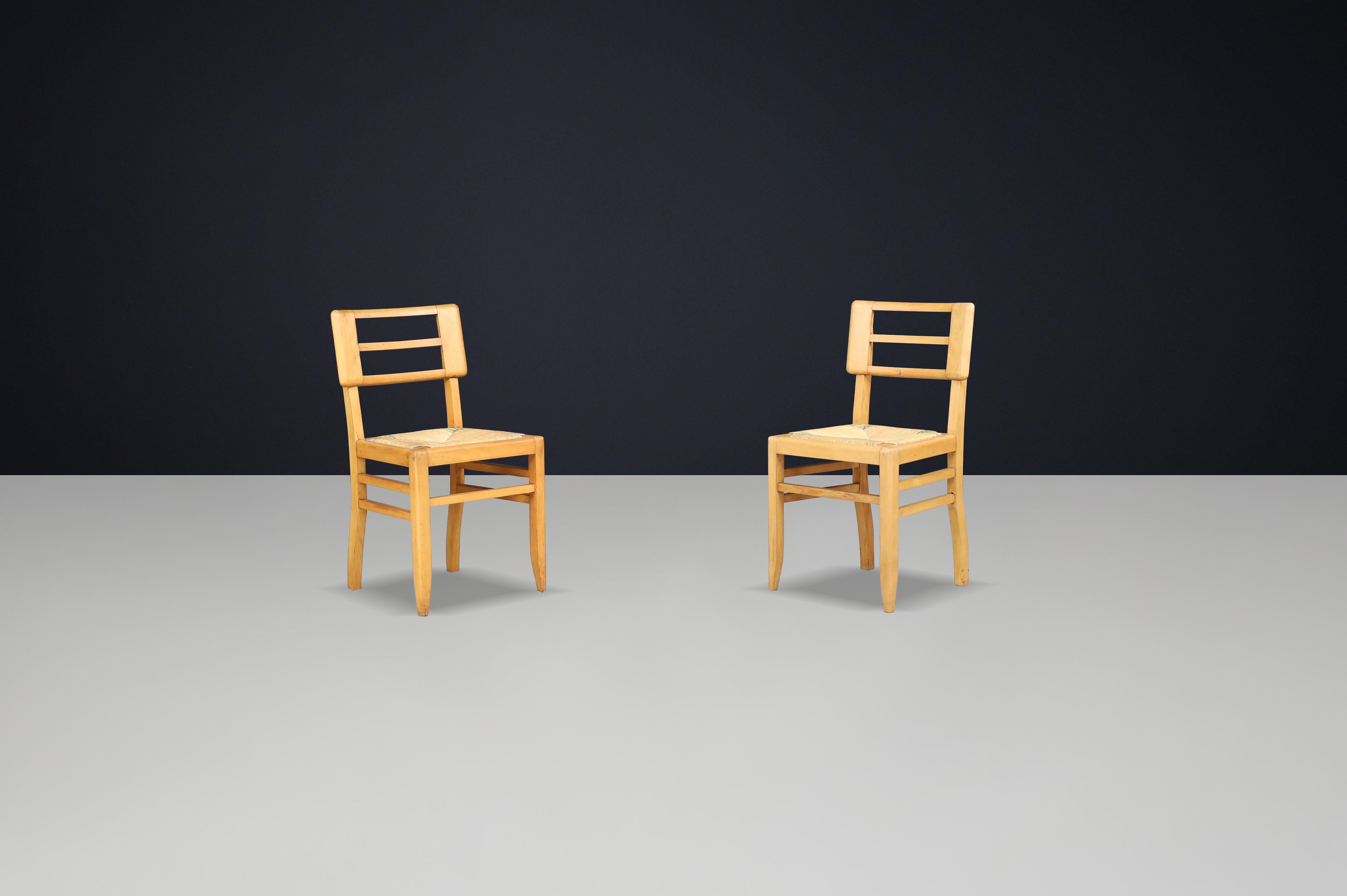 Rare Pair of 1940s French Mid-Century Modern Oak and Cane Side Chairs by Pierre Cruège

An exceptional pair of mid-century modern side chairs designed by French architect Pierre Cruège, crafted in France during the 1940s. These chairs embody the