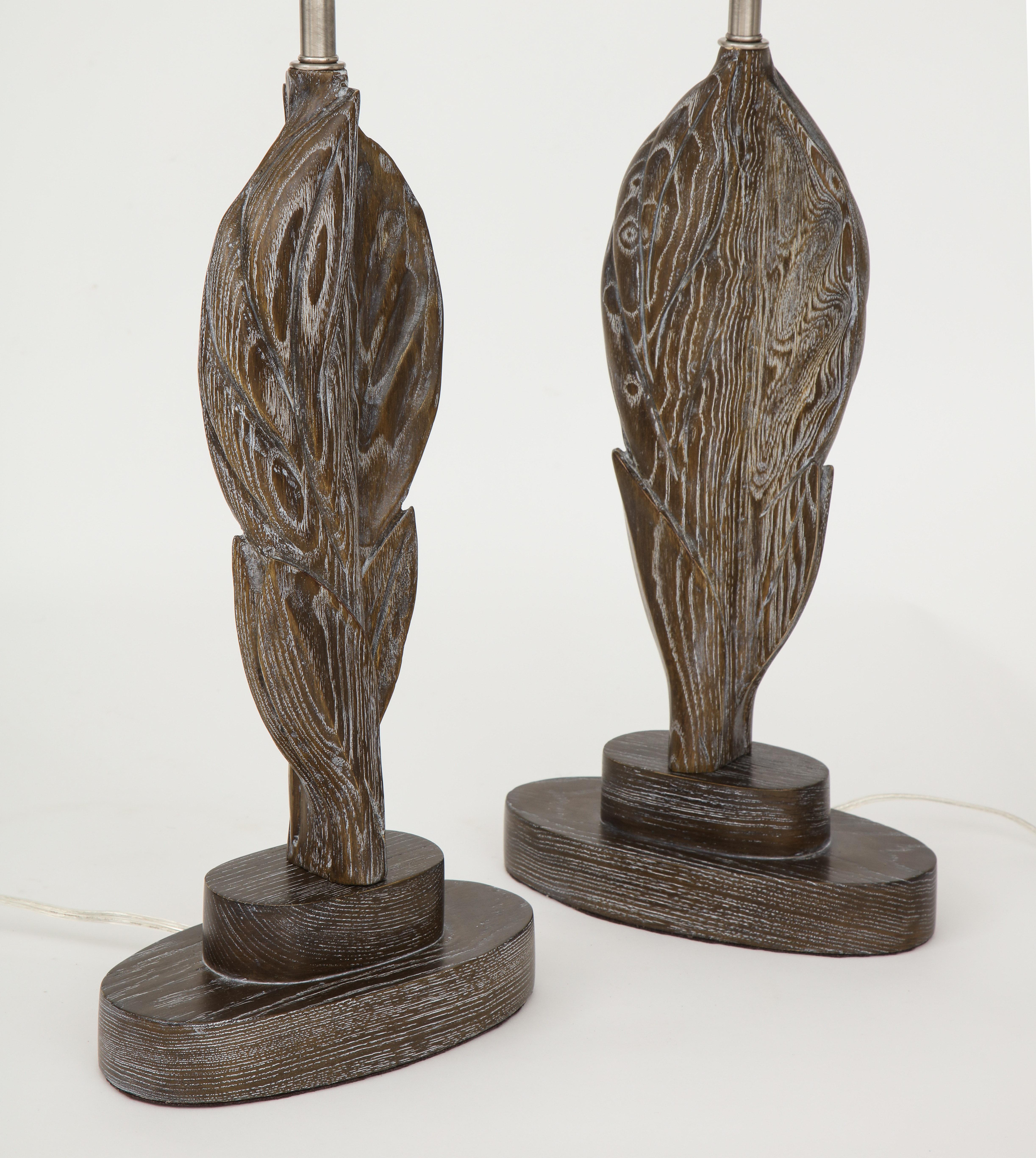 Pair of French Moderne hand carved oak stylized leaf lamps with a cerused finish. Rewired for use in the USA with satin nickel sockets, 100W max bulbs.