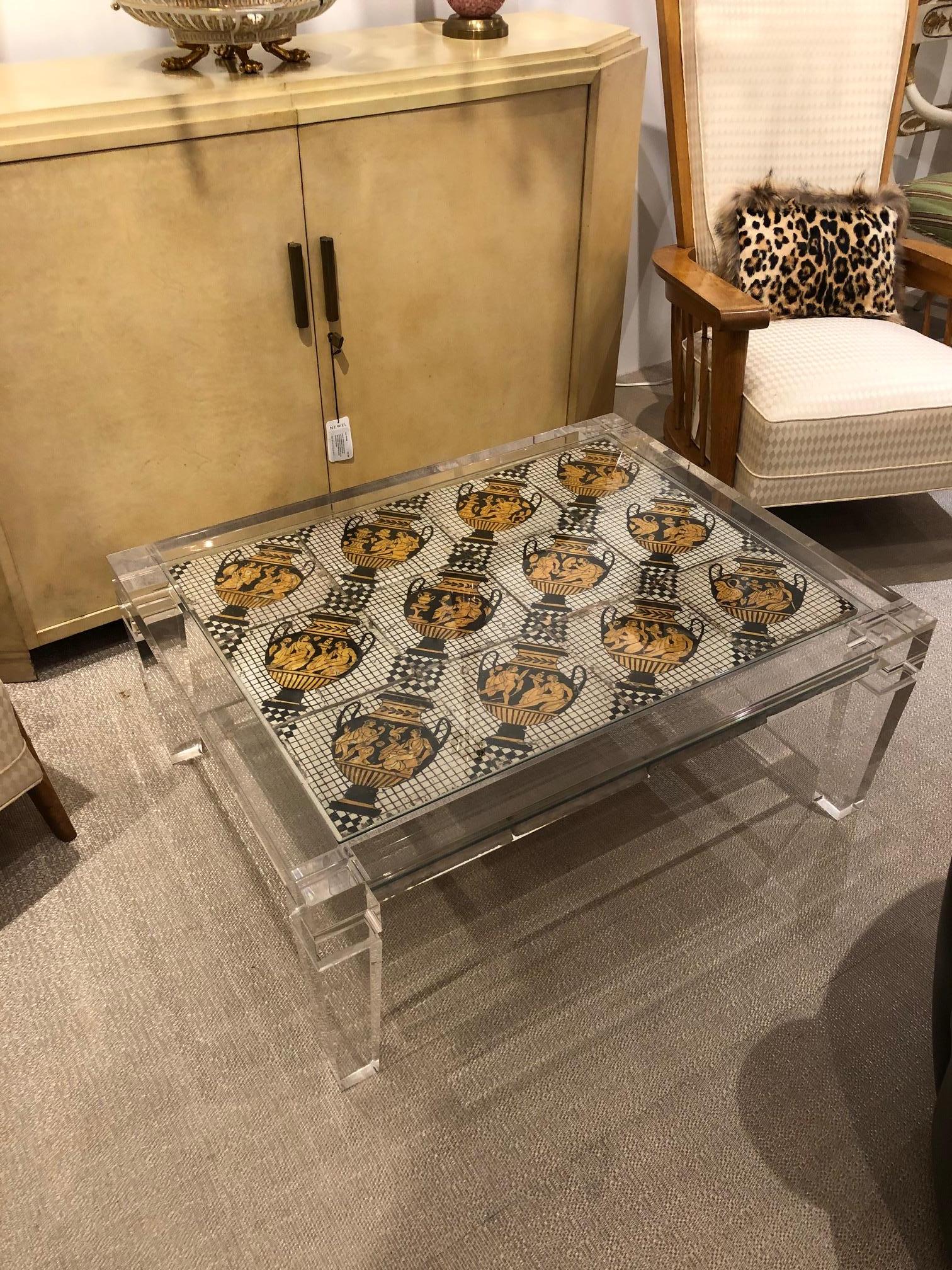 French (1940s) rectangular lucite coffee table with twelve black, white, and gold tiles with classical urn design. (attributed to: MAISON JANSEN)
