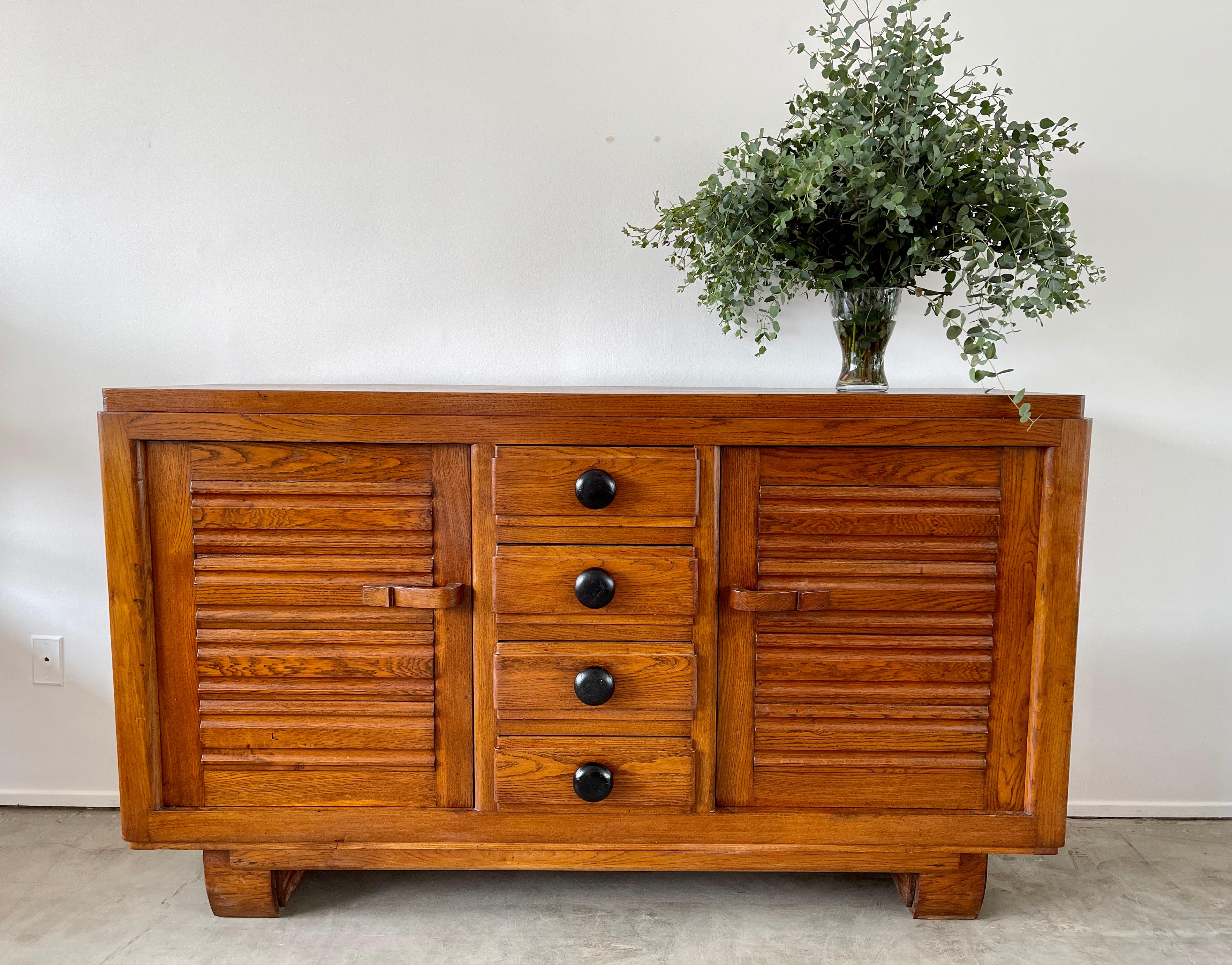 1940's French oak cabinet attributed to Rene Gabriel with fantastic patina. 
Center row of drawers - oversized wood handles and 2 doors with open storage / shelving.