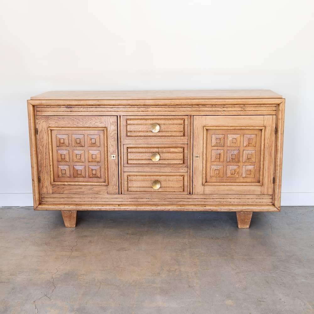 Incredible wood sideboard by Charles Dudouyt from France, 1940's. Beautiful carved wood squares with square detail on cabinet doors and carved legs. Center has three drawers with chunky brass knobs. Two interior side sections each with a middle
