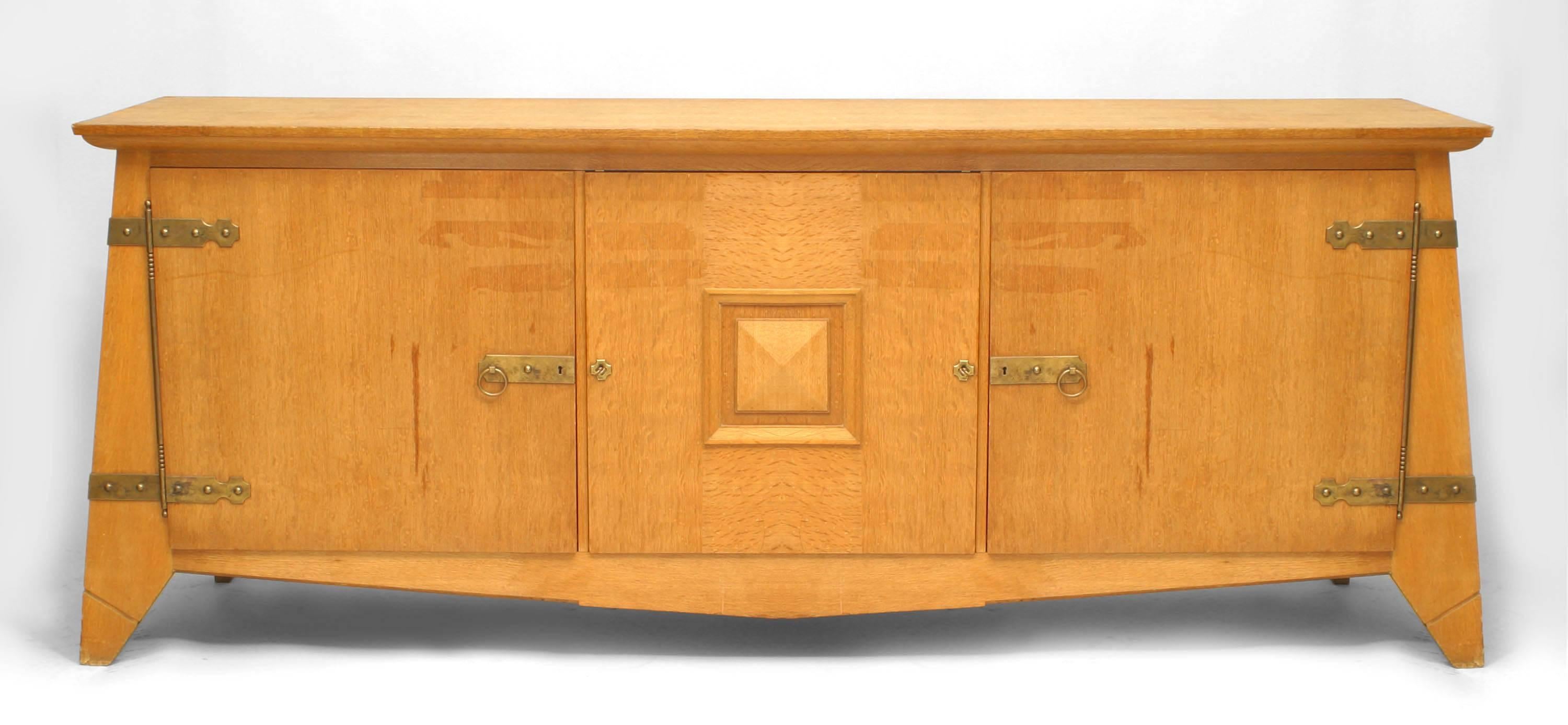1940's French oak sideboard with three doors and brass hardware on splayed feet.