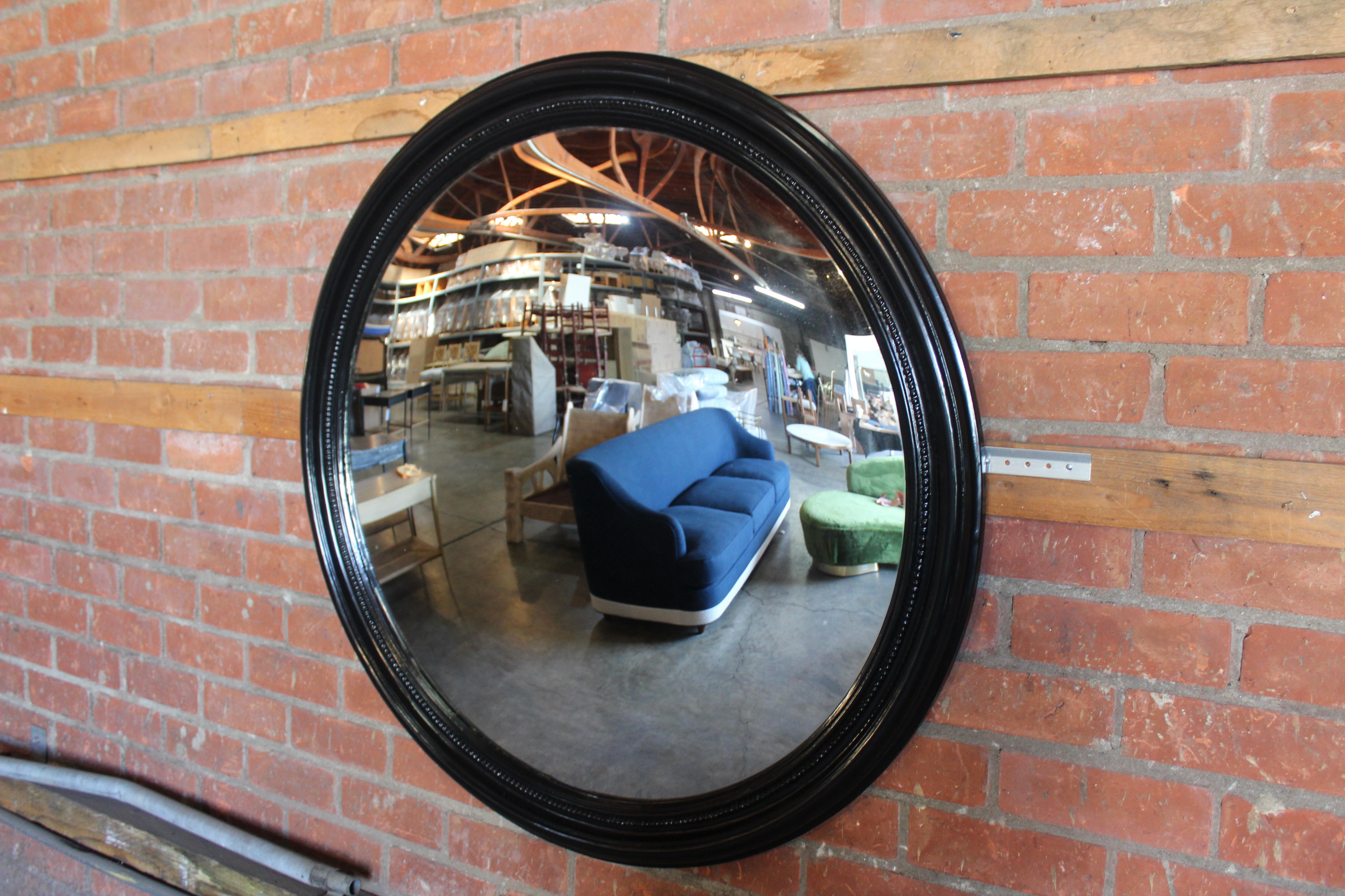 A vintage French convex mirror, 1940s, found in Paris. Black frame. Overall good condition.