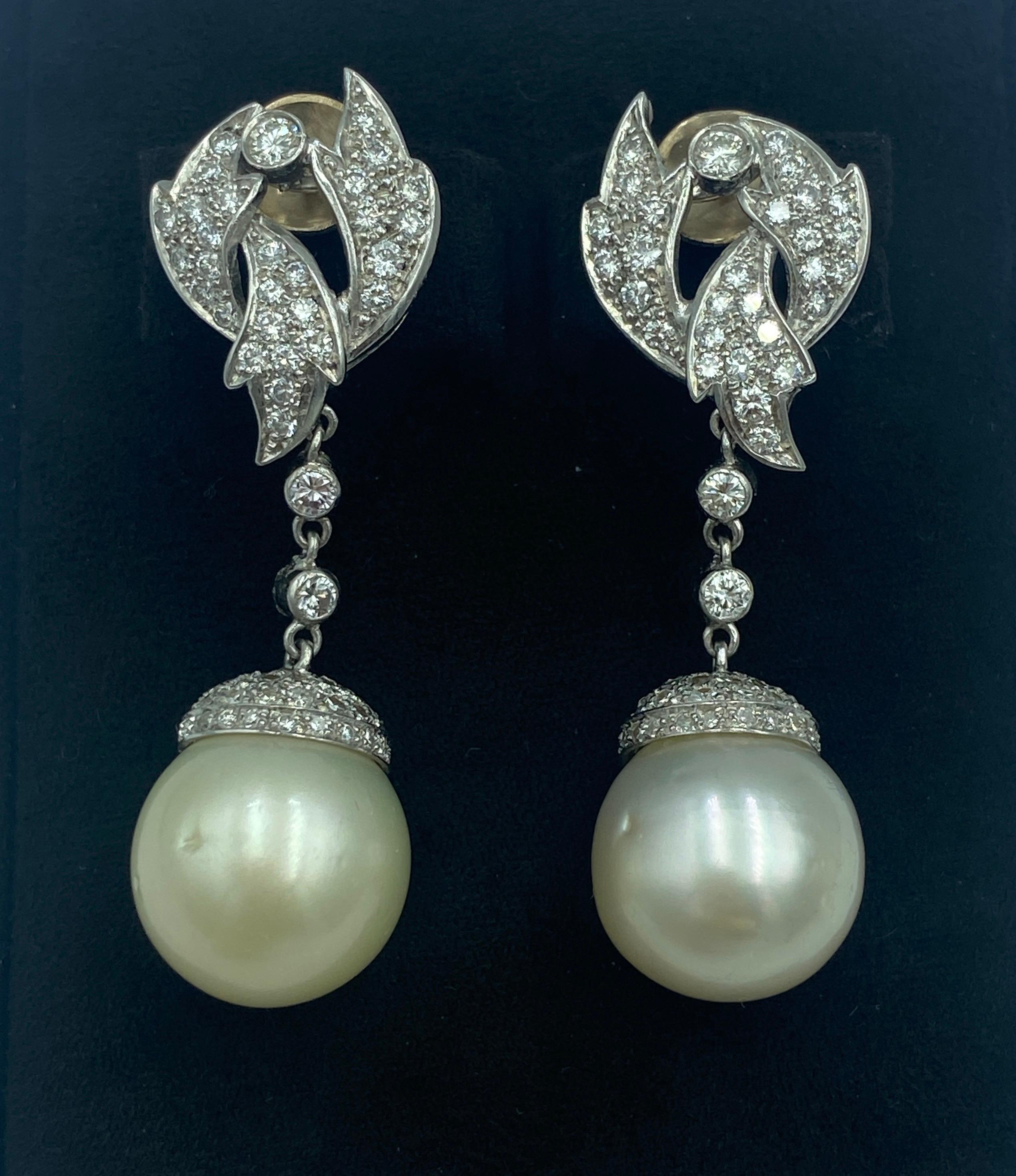 These 1940s French platinum, diamond and pearl dangle earrings are clip-on earrings but a post can easily be attached to them. The pearls are South Sea natural pearls and their diameter is 16 mm. There is approximately 3 carats of diamonds on these