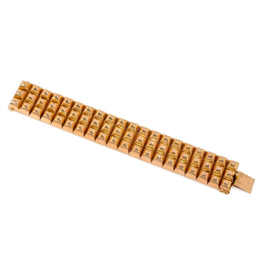 A Retro rose gold bracelet comprised of three rows of pyramid-shaped links, in 18k. France.