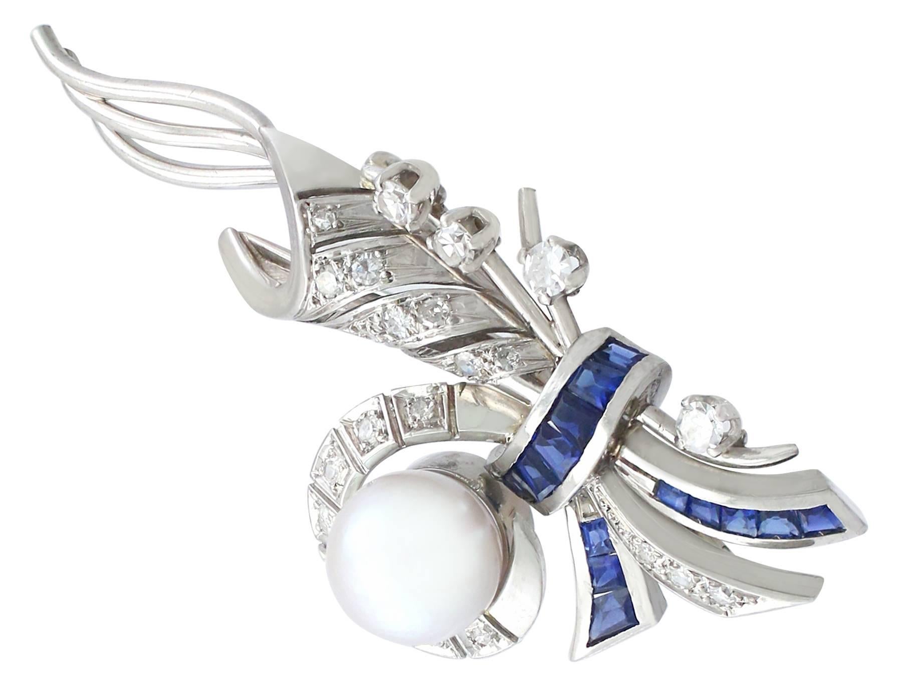 A stunning vintage French 0.84 Ct sapphire and 0.77 Ct diamond, cultured pearl and platinum spray brooch with a 18k white gold pin; part of our diverse vintage jewelry collections.

This stunning, fine and impressive diamond, pearl and sapphire