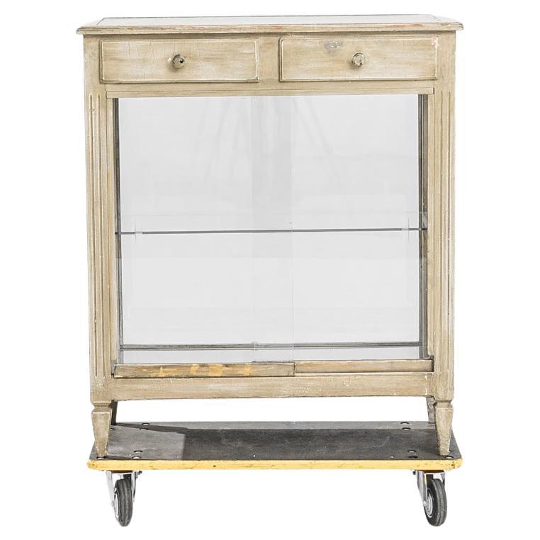 Immerse yourself in the elegance of the past with this charming 1940s French Small Wooden Vitrine. A vitrine of this stature exudes the sophistication of its era, with its delicate woodwork finished in a light patina that suggests stories and