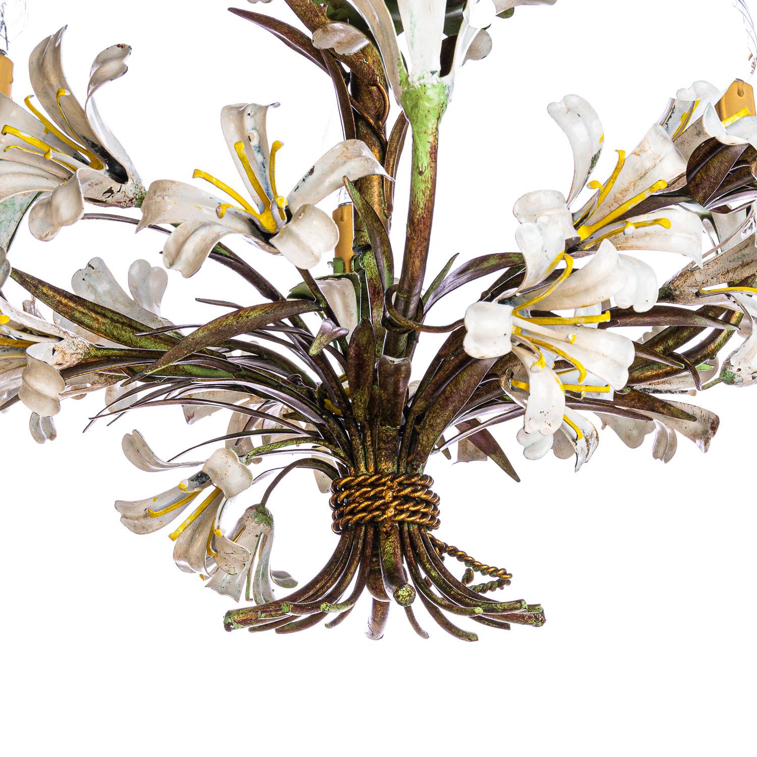 Stunning 4 light fixture with painted Lily's white and yellow polychromed metal Toleware. Gorgeous faux wax candlestick light holders on a green holder mounted on a white lily. Gold and green color through out the base. 
We have a short extra chain