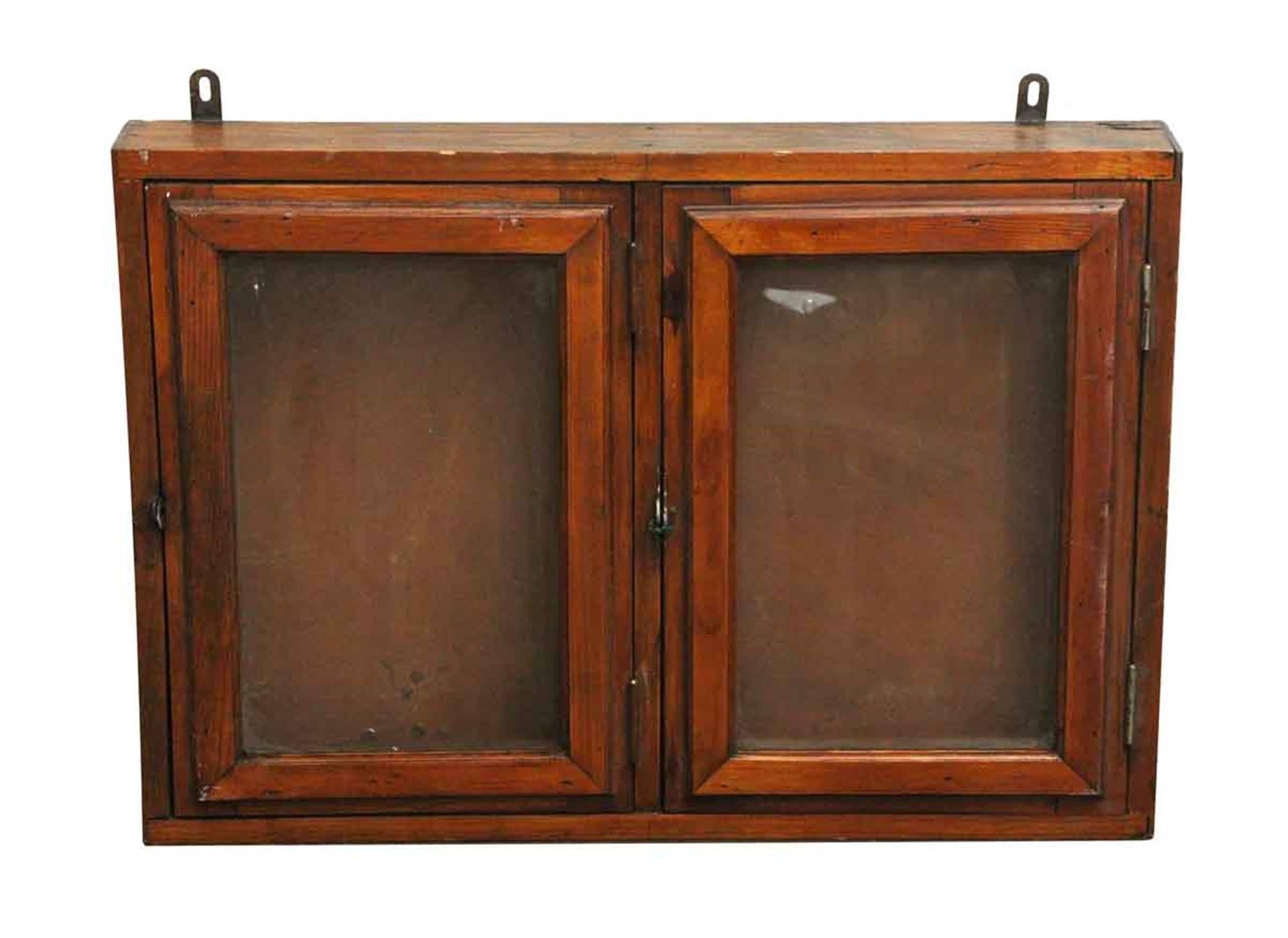 1940s French two-door oak and glass display case with a nice patina on the wood. This can be seen at our 302 Bowery location in Manhattan.