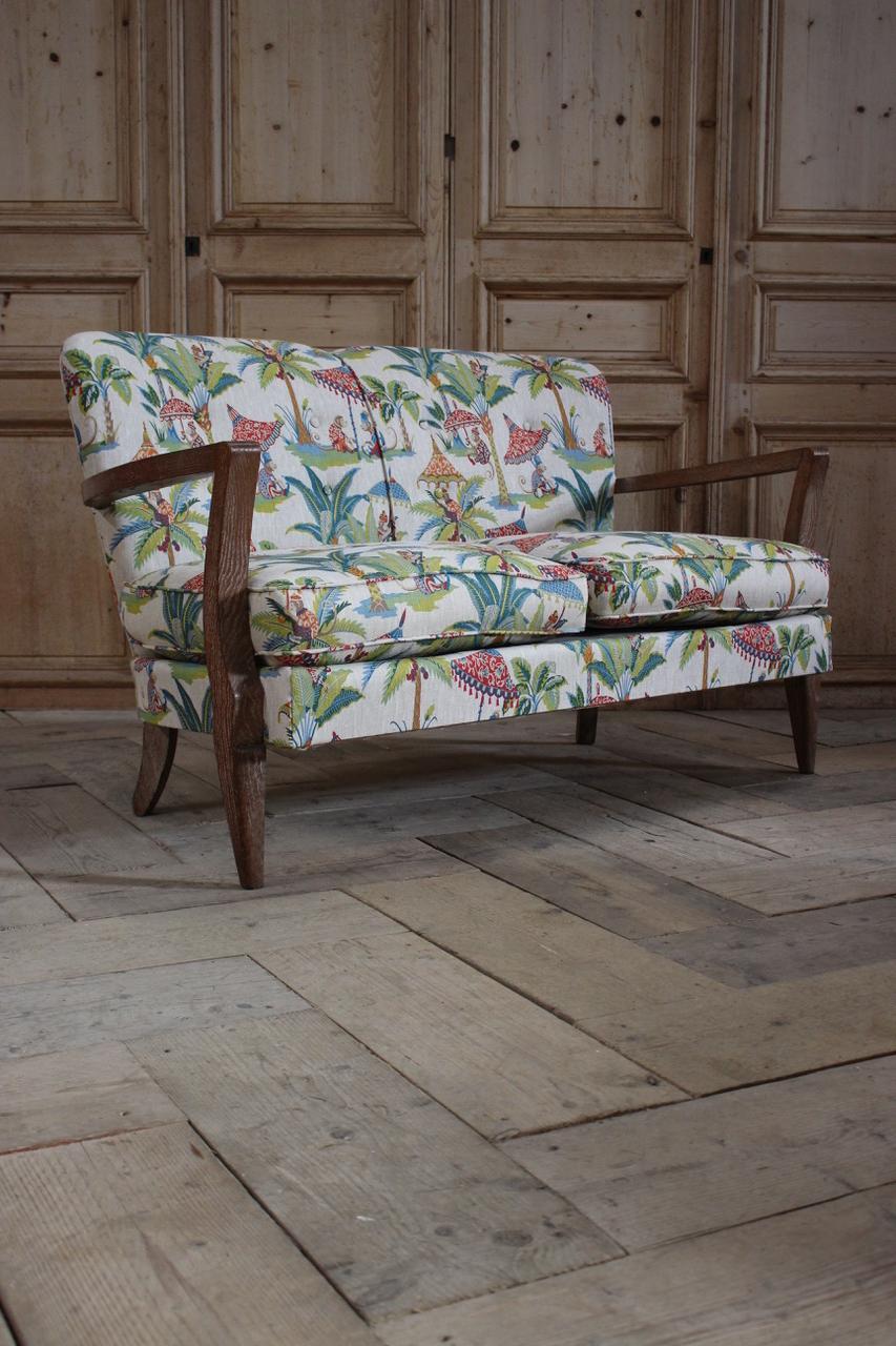A very stylish and recently reupholstered in a wonderful printed linen, circa 1940s French two-seat sofa, that will make a statement in most settings.
Great proportions and fabric. 

Measures: 45cm high (floor to seat). 
 