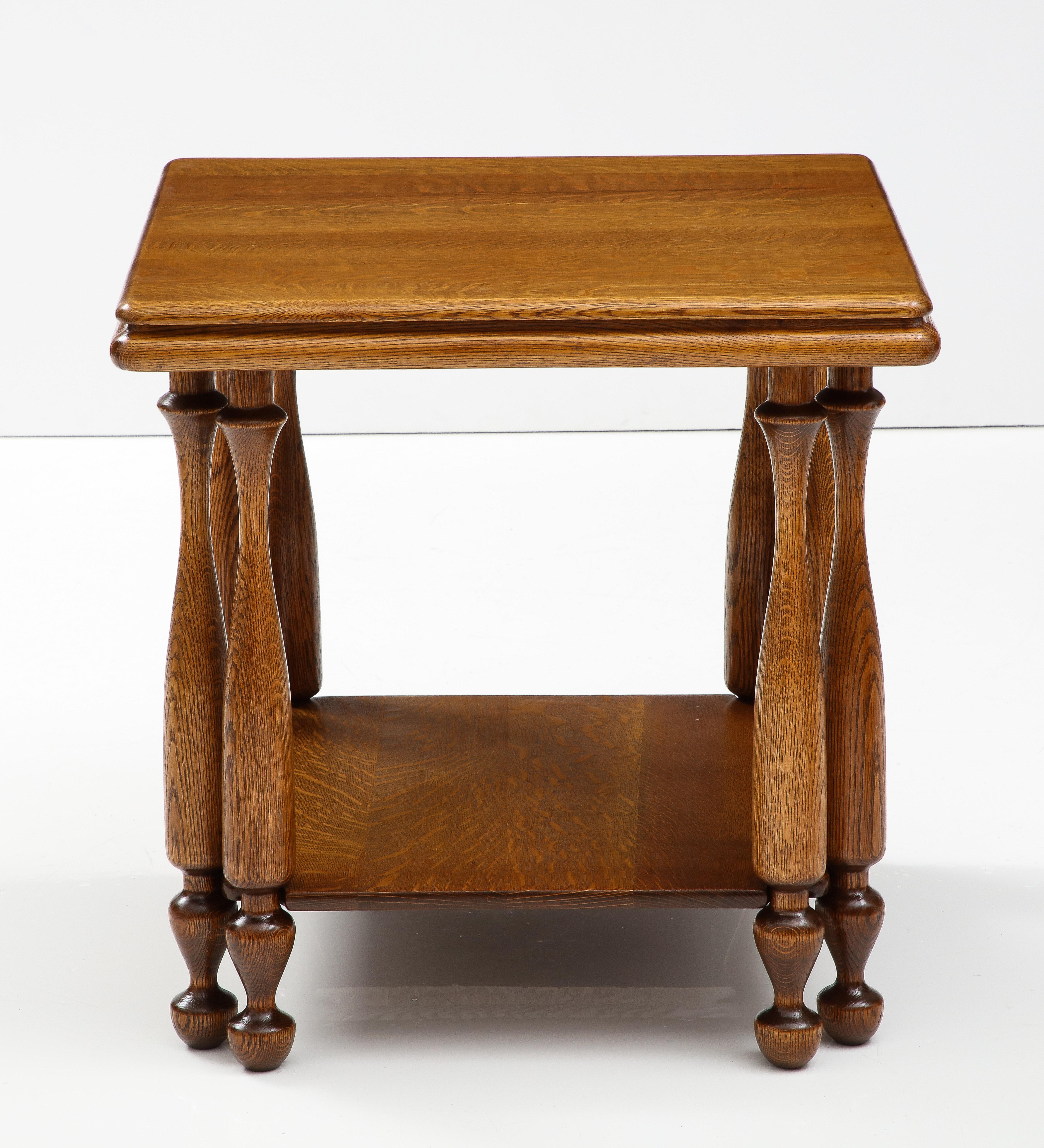 1940's Large two tier oak French end/game table with carved double legs, lightly restored with minor wear and patina due to age and use.