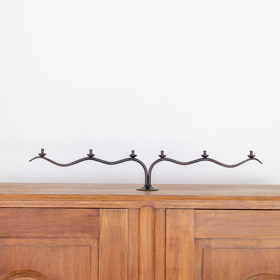 Incredible long wavy iron candlestick from France, 1940's. Beautiful thin curved iron frame with six petite heads to hold candles. Iron shows great age and patina. 