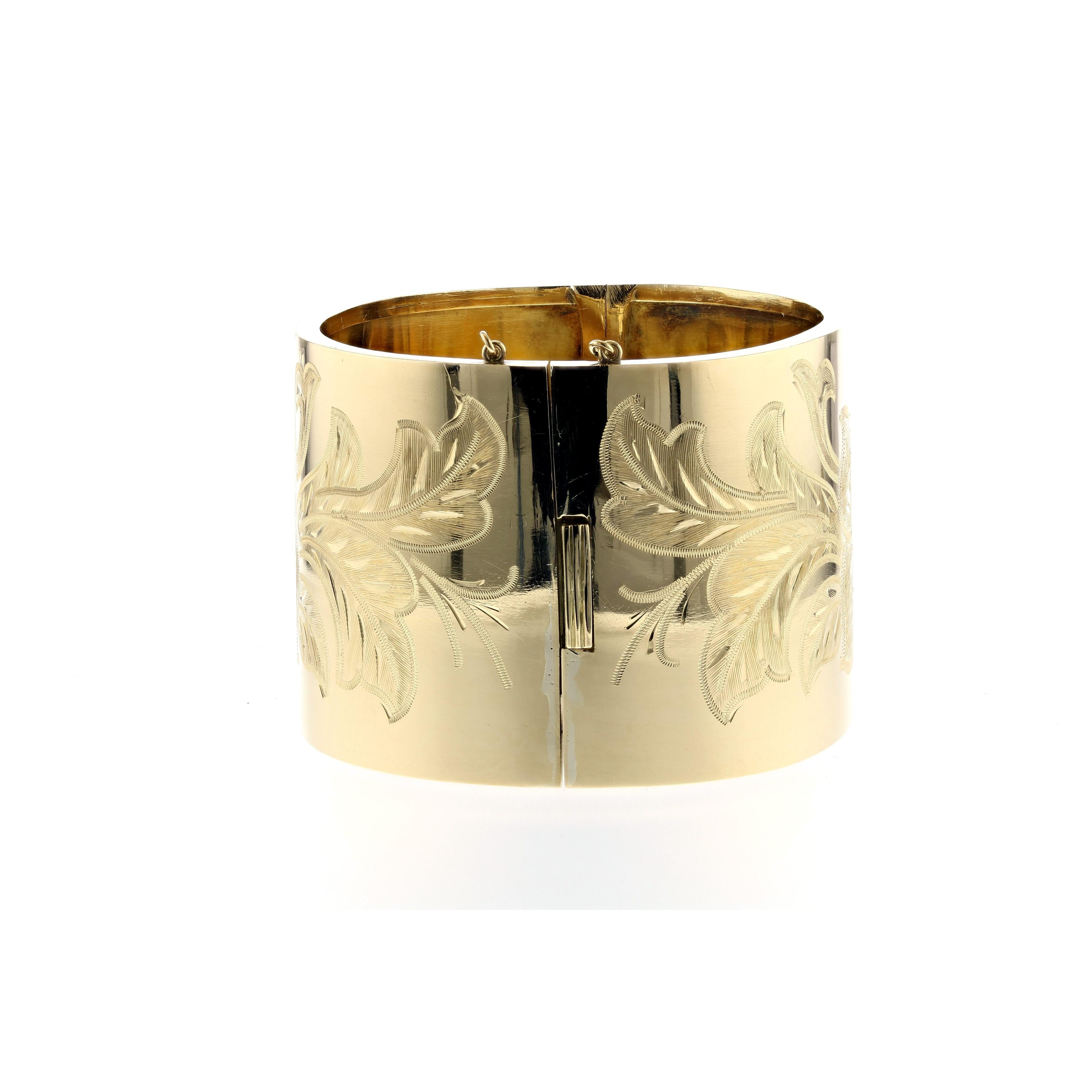 French Victorian Revival 18K yellow gold wide bangle with engraved floral motif on both sides.  Circa 1940.  Circumference is 7 inches.