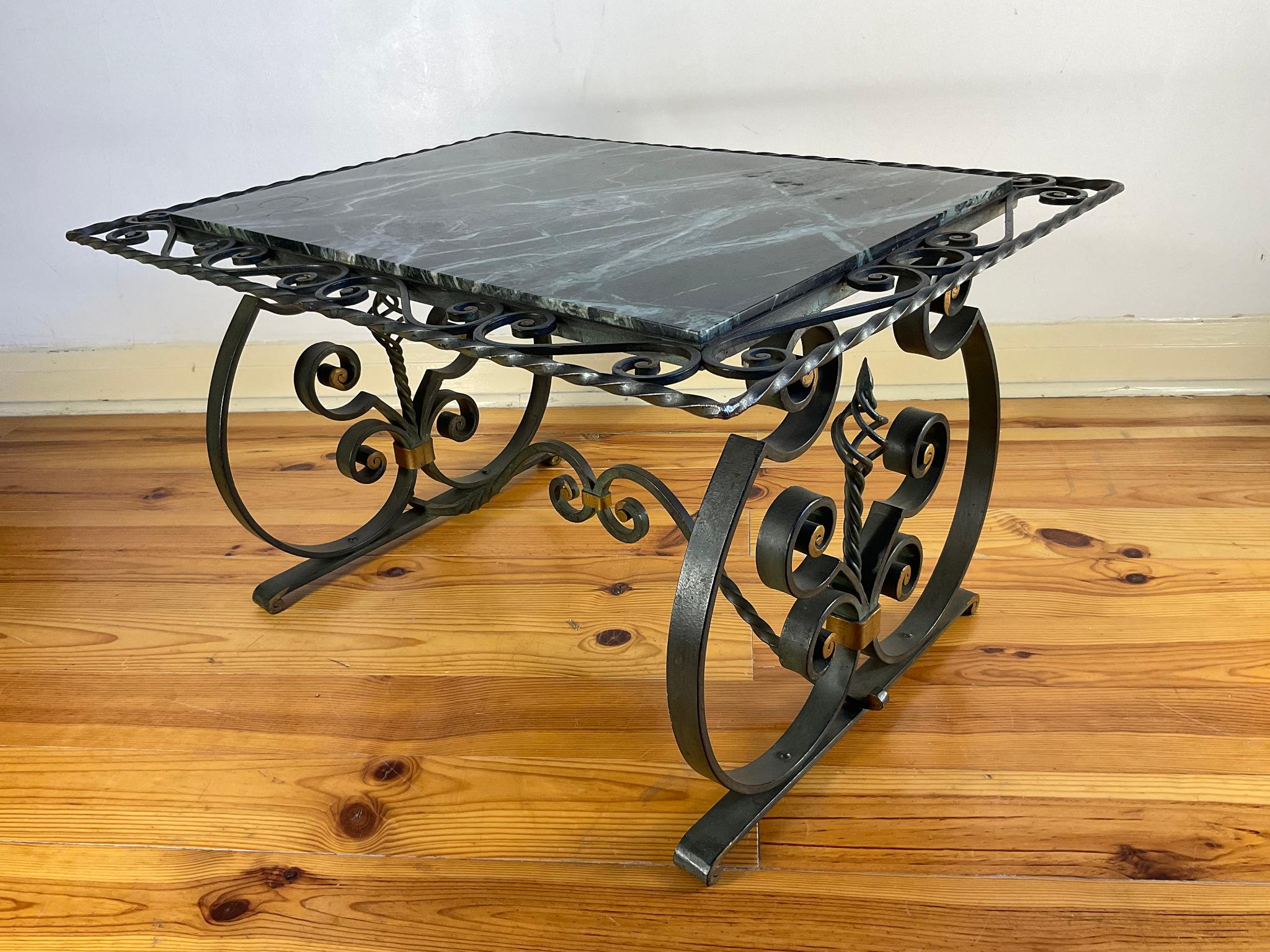 The 1940s wrought iron coffee table with an Alpine green marble top.